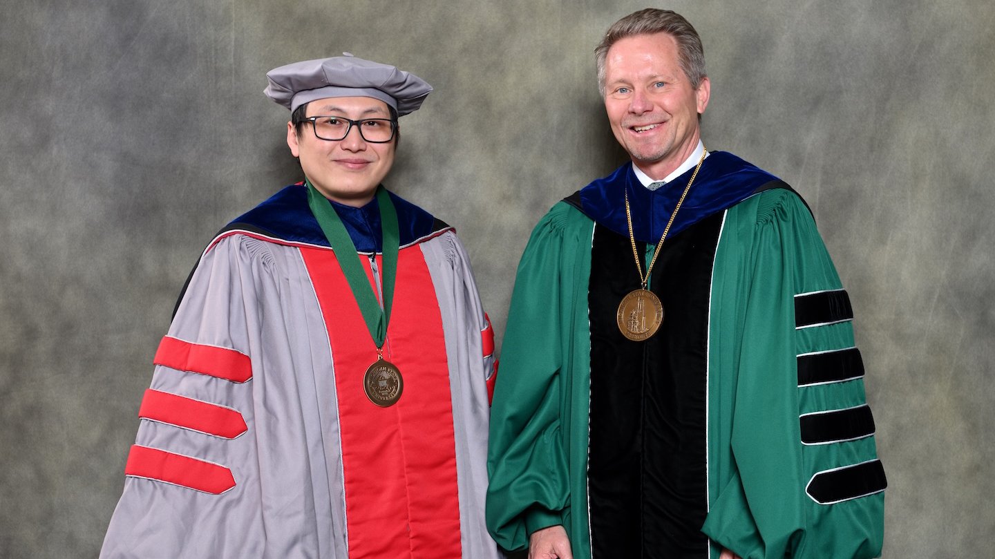Endowed faculty member Tuo Wang with MSU President Kevin Guskiewicz.