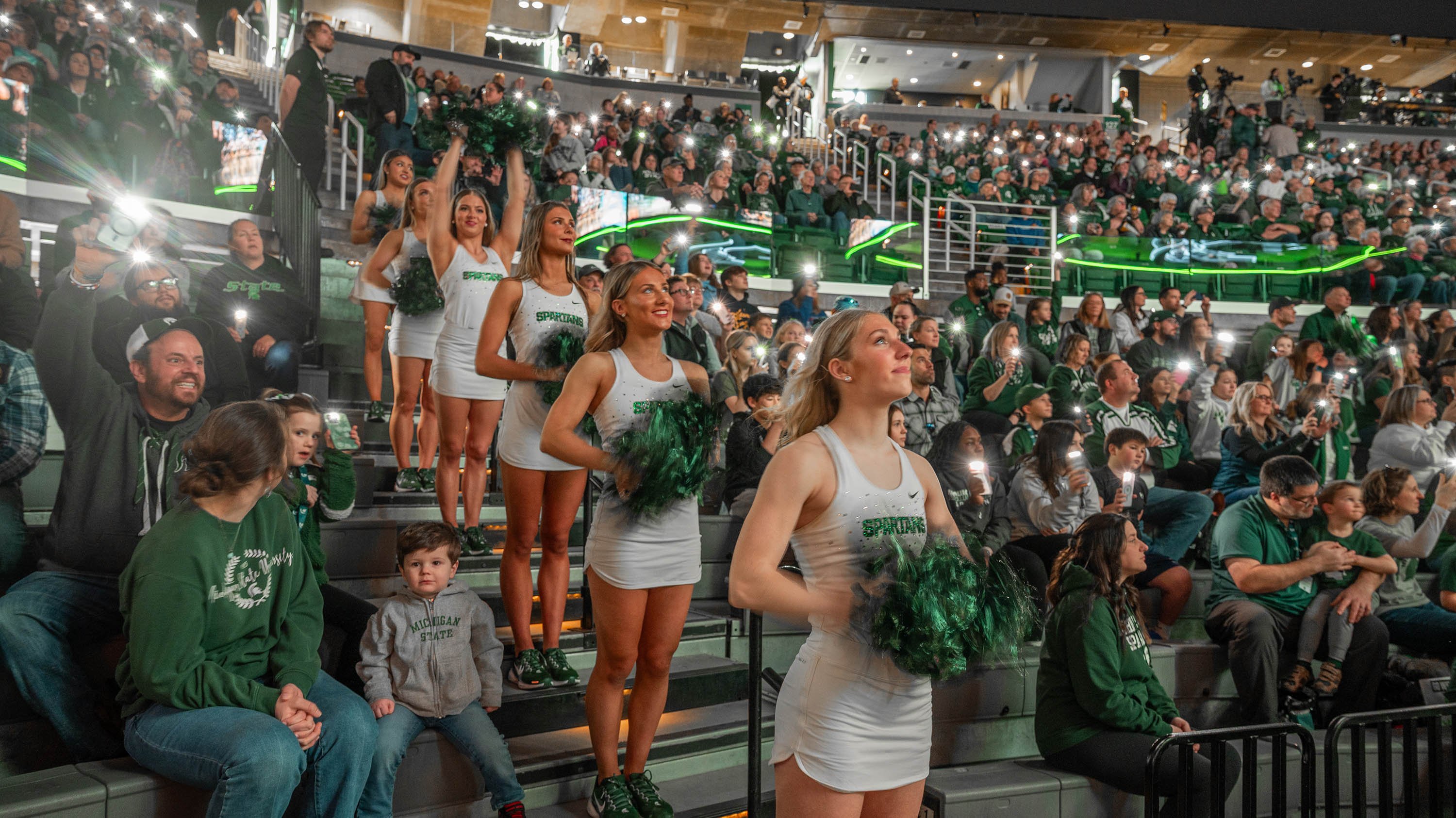 MSU cheerleaders in the stands with crowd at MSU women's basketball game