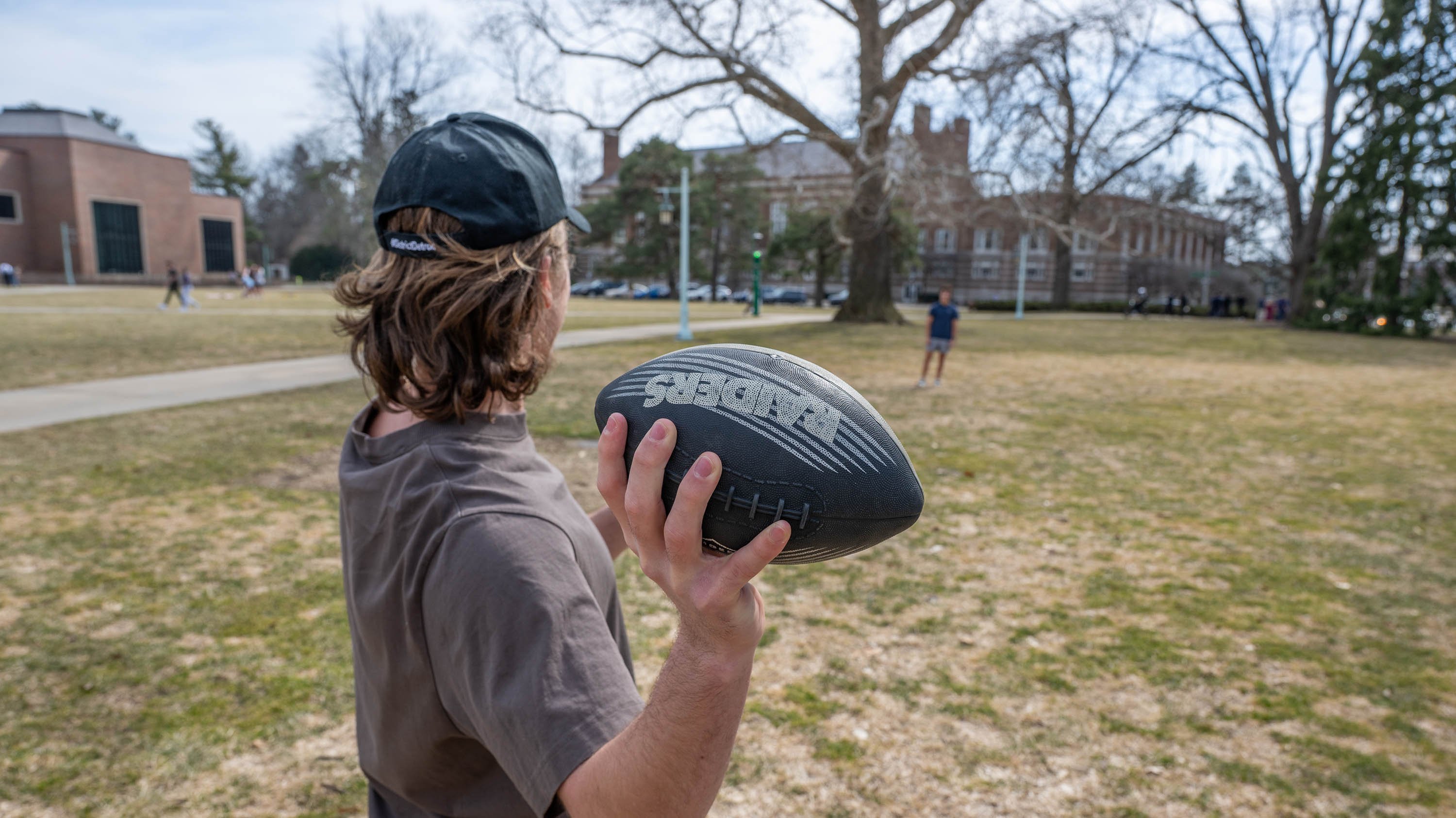 Student throwing football