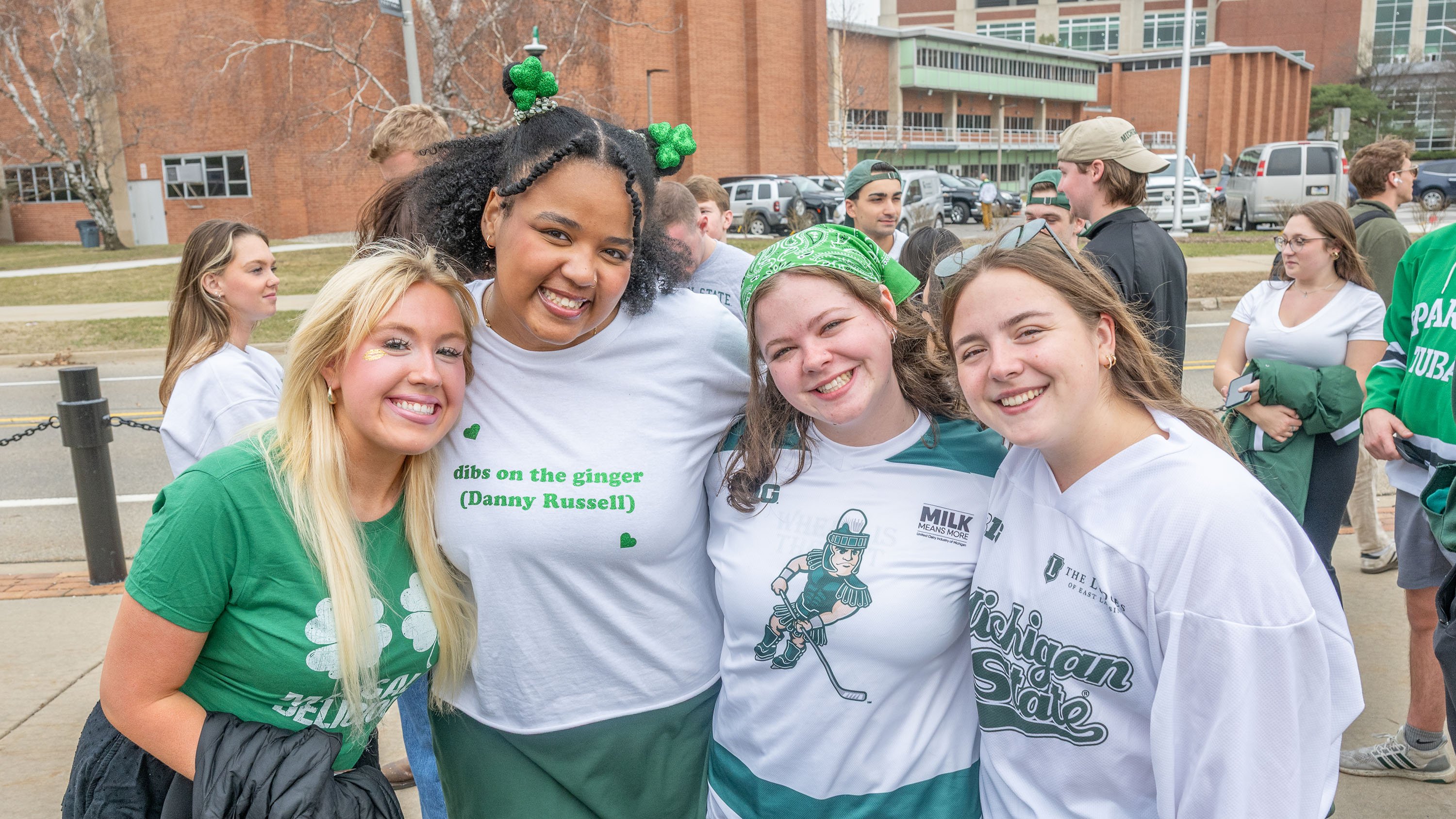 Hockey fans posing outside Munn arena