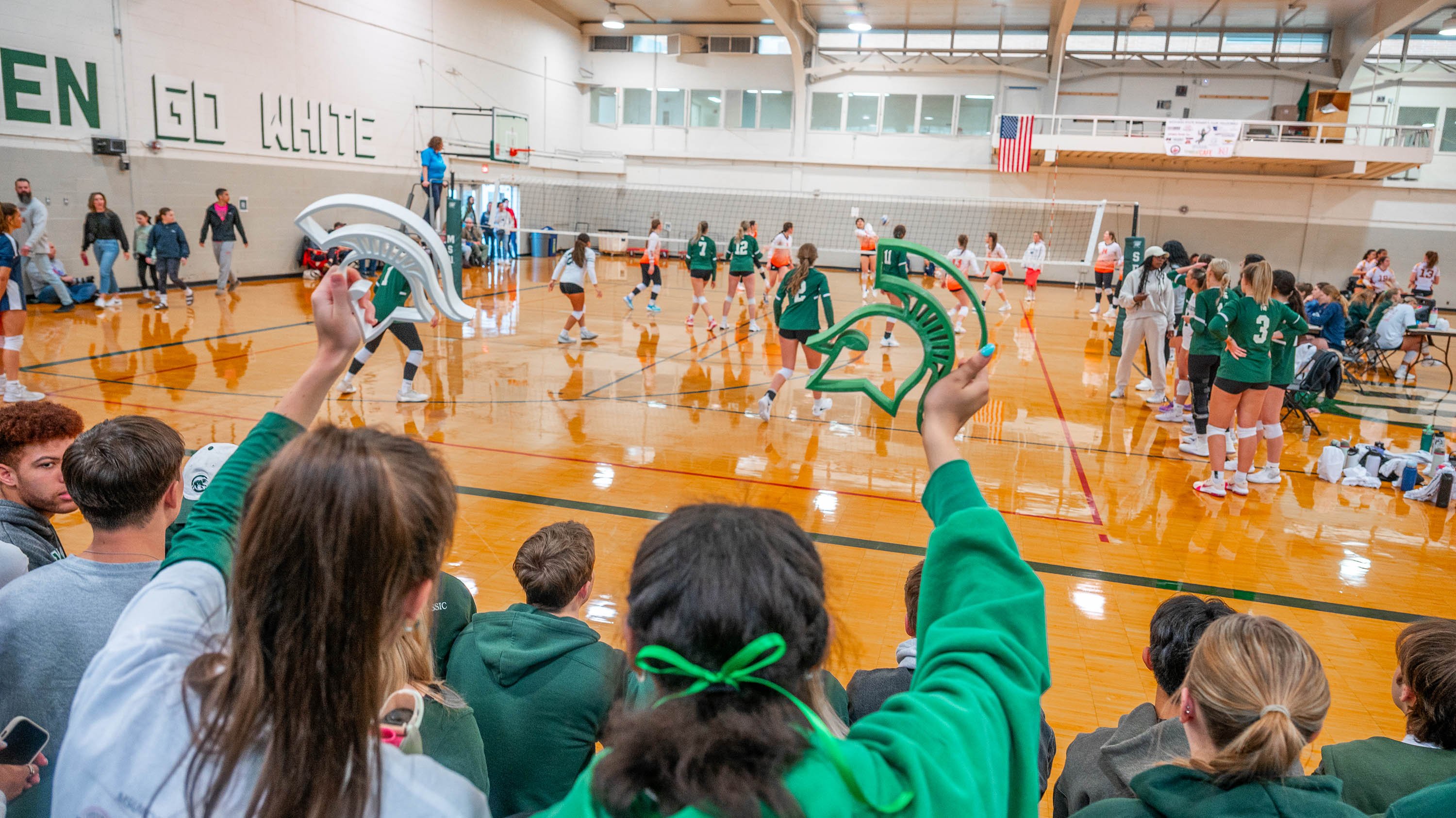 Spectators cheering for MSU volleyball club