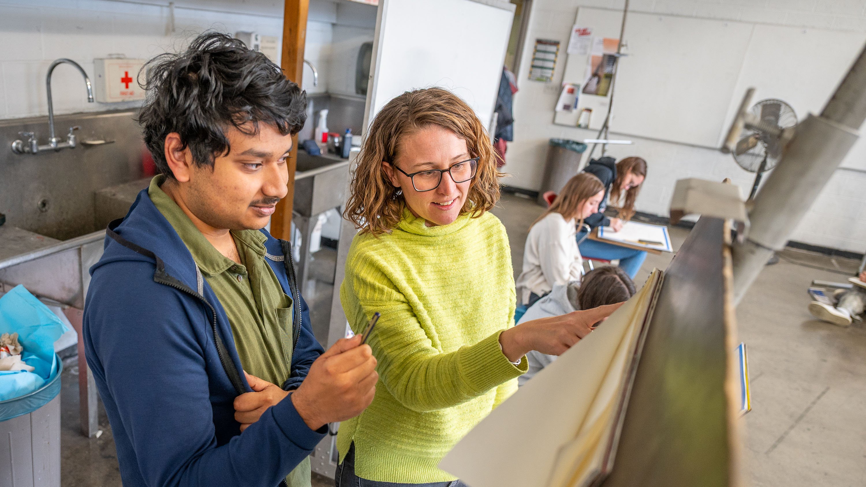 Candice Chovanec working with student in drawingclass