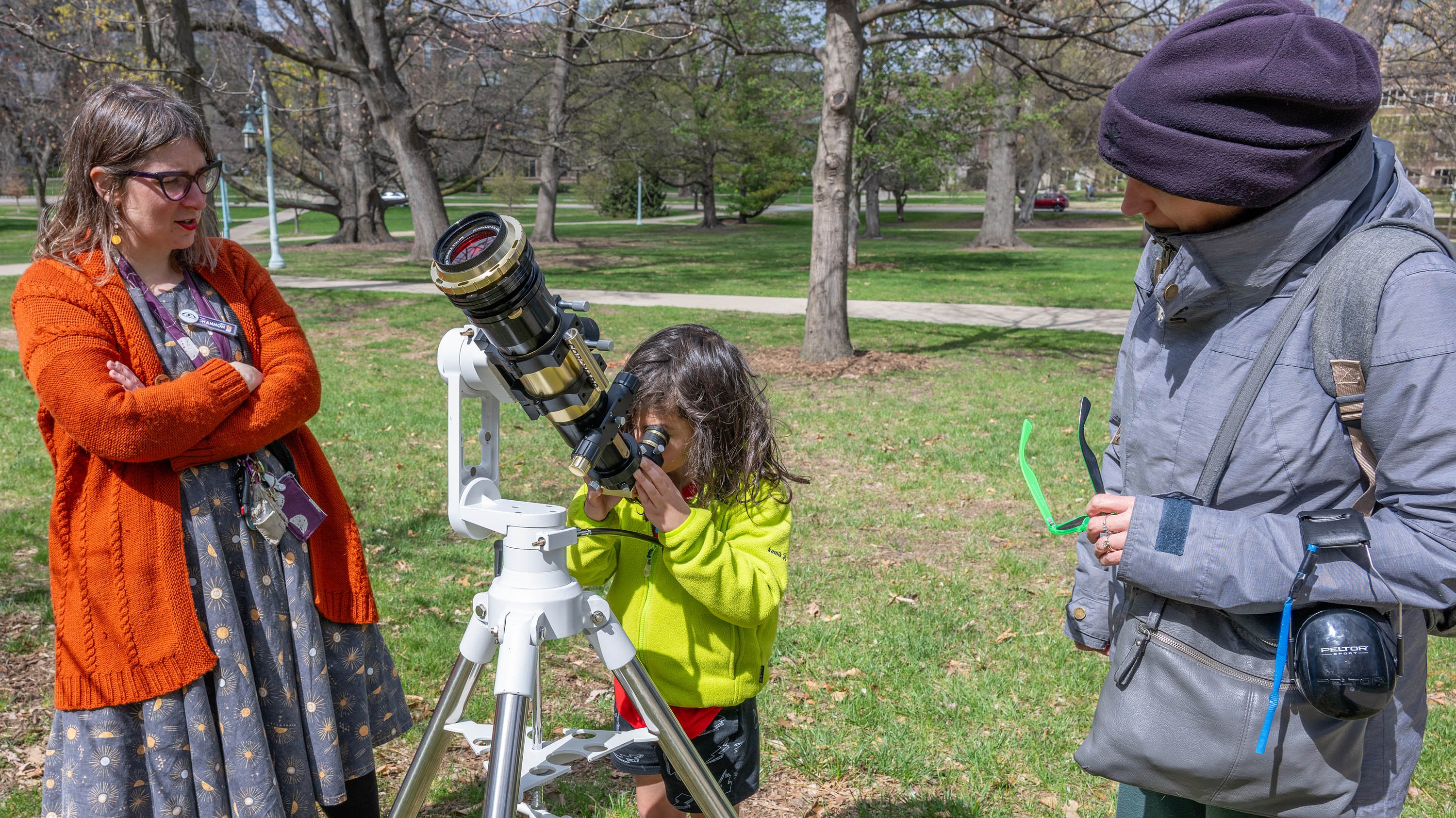 Child looking through a telescope