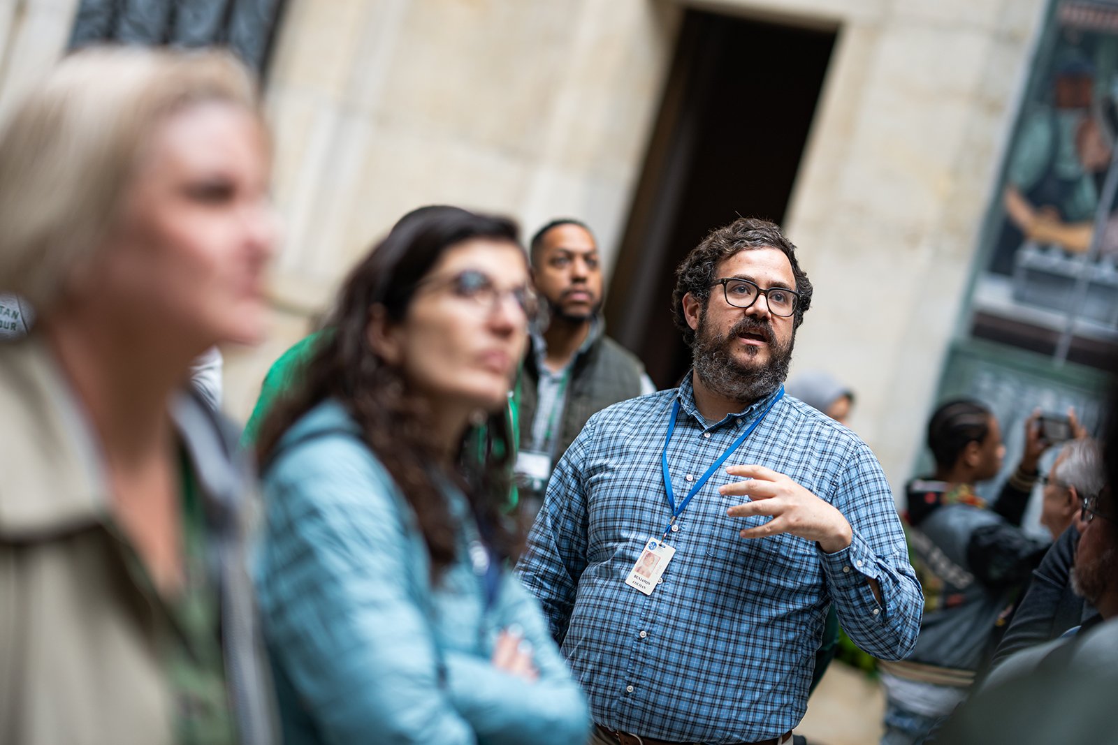  A man speaks as a group of people listen