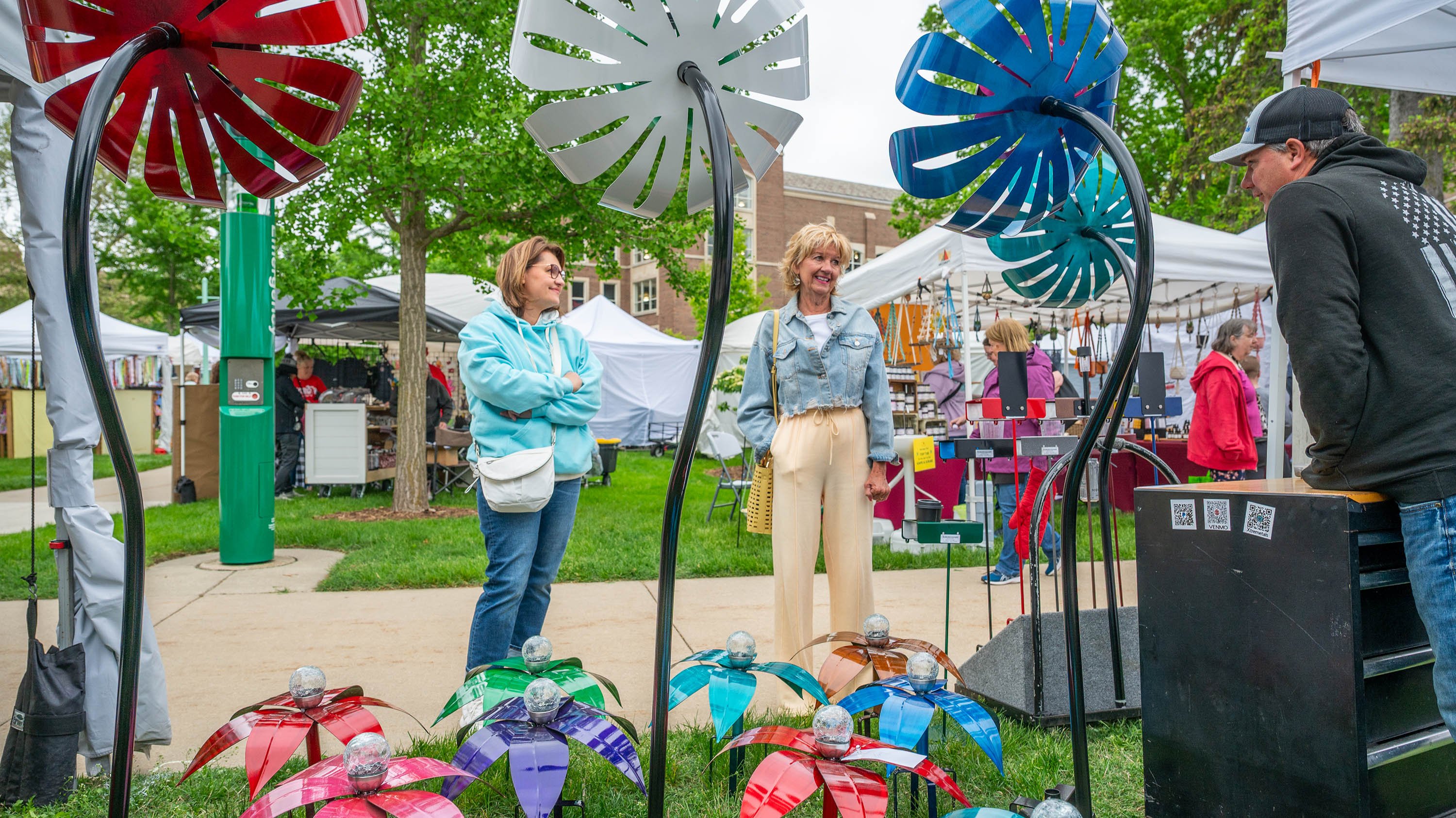 People talking to artist at Spring Arts and Crafts fair