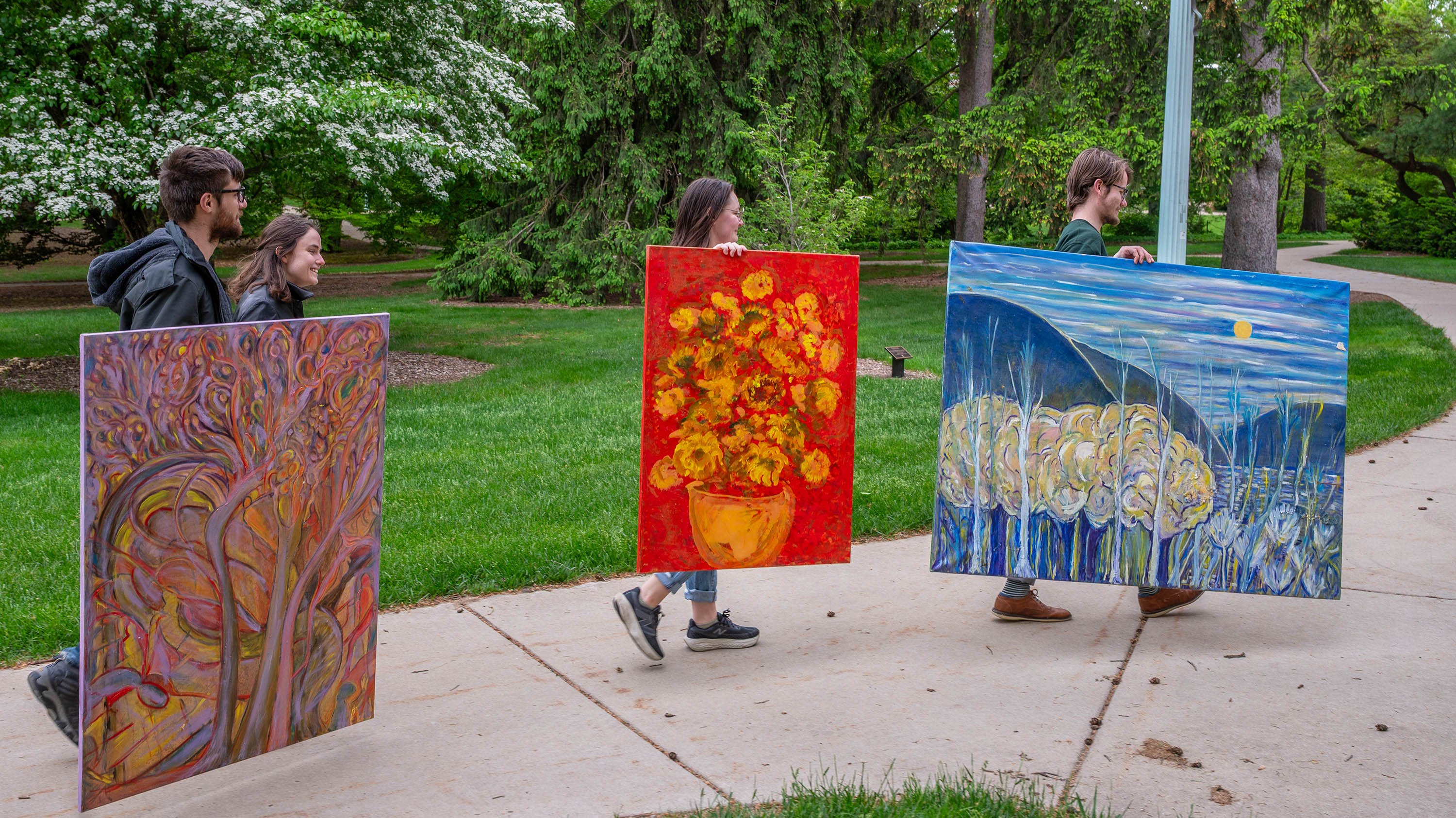 People walking with paintings
