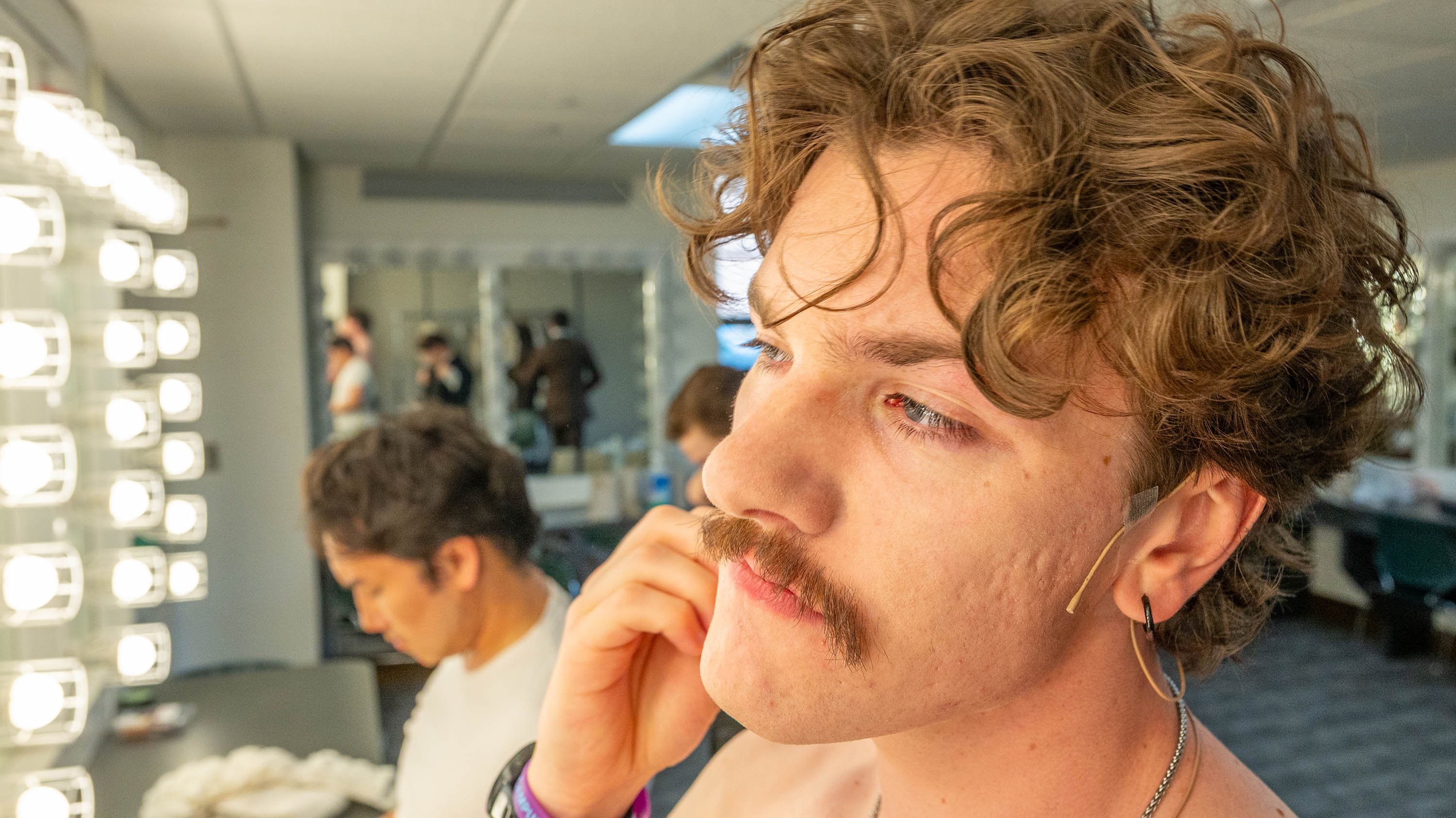 Actors putting makeup on before Summer Circle Theatre production