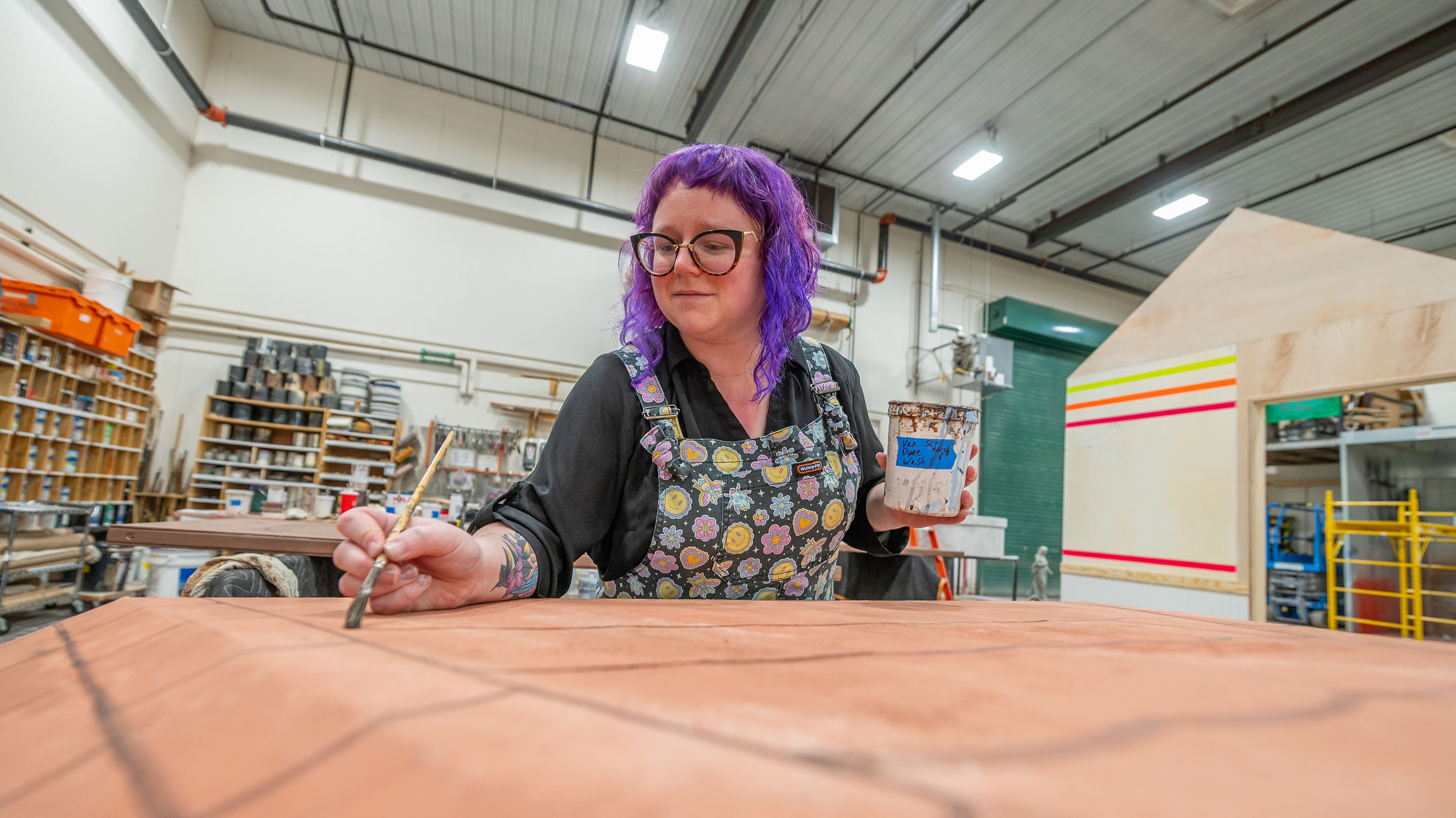 Crew member building set for Summer Circle Theatre production