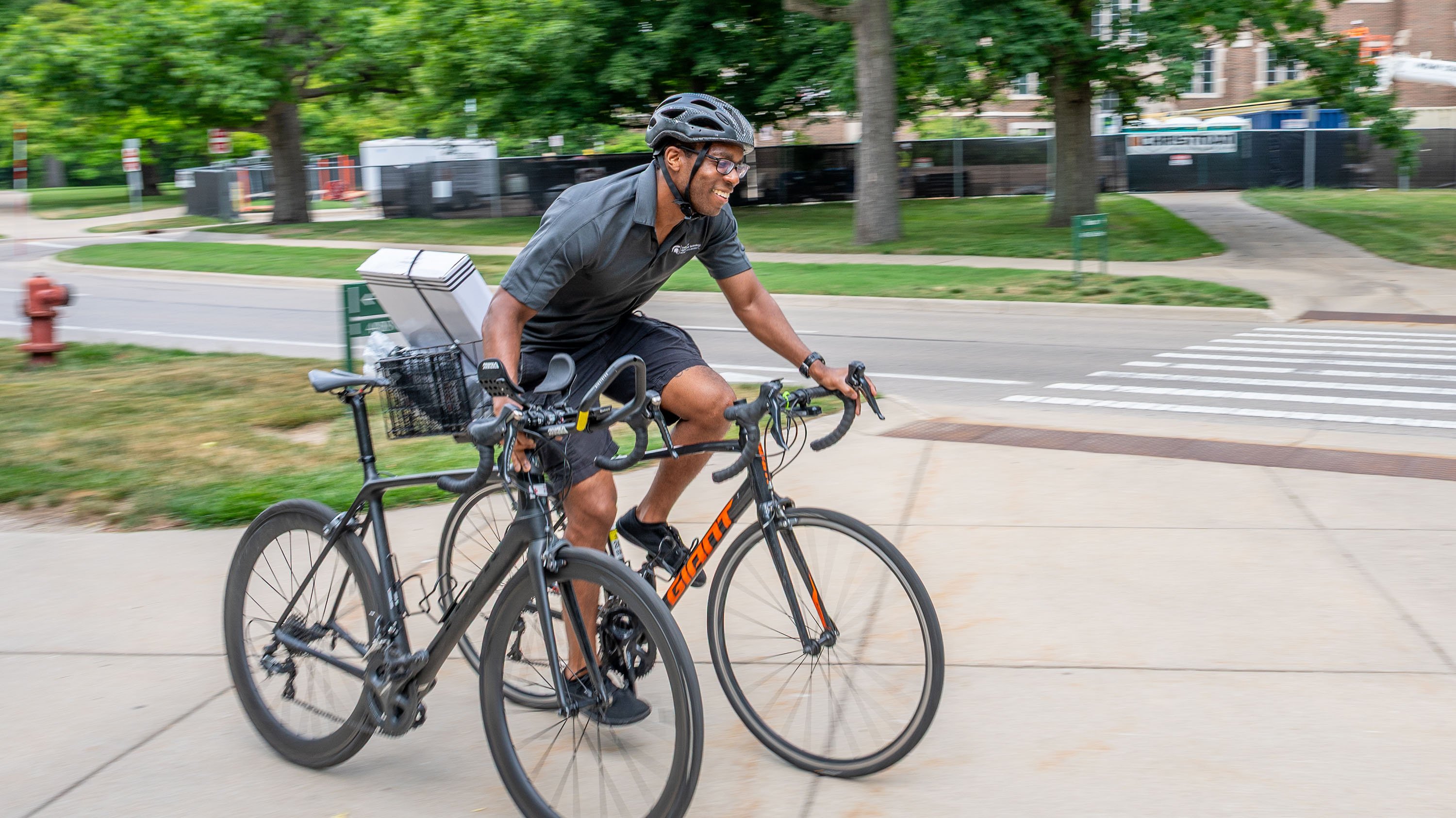 A Spartan ghost ride a bike to MSU Bikes Service Center