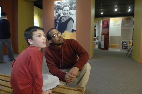 A man and a child visit an exhibit at the MSU museum.