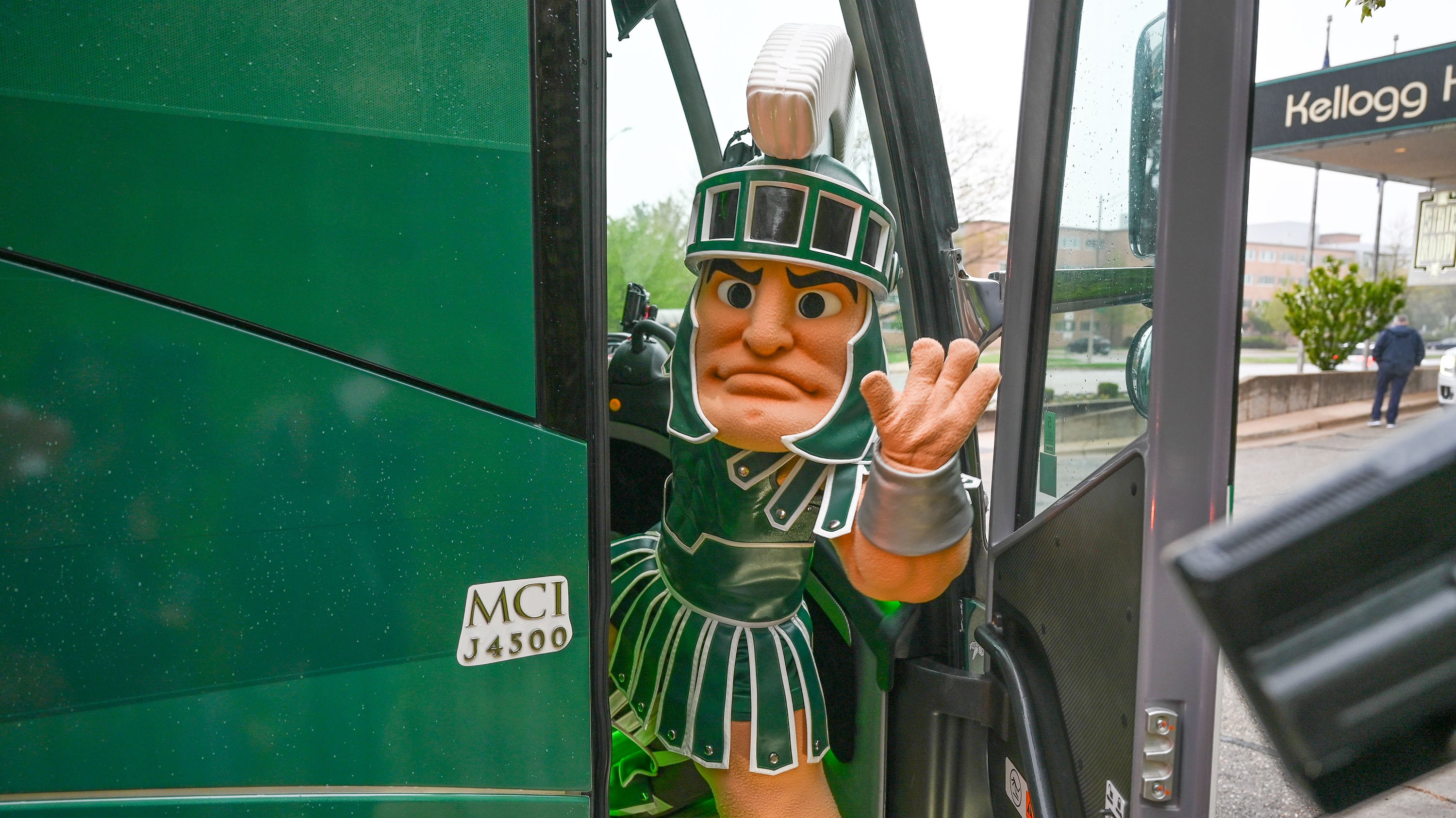 Sparty entering a bus