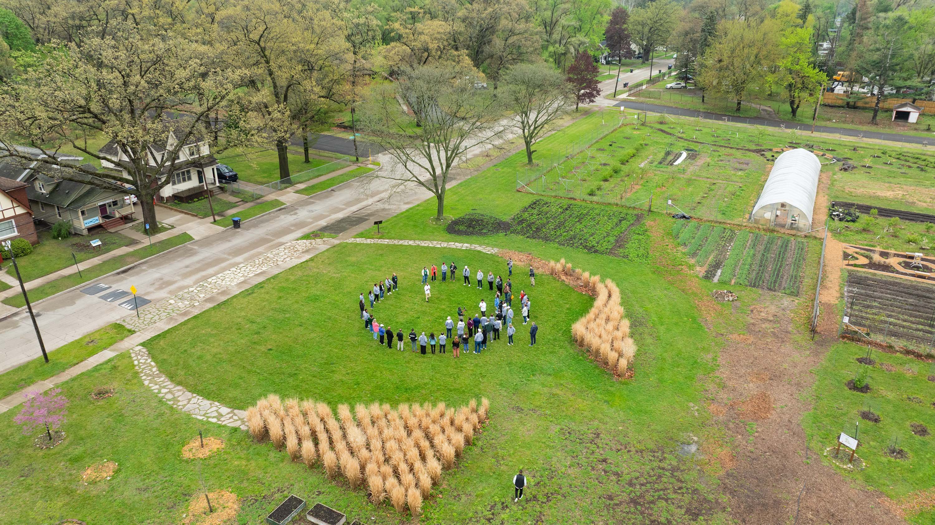 Aerial photo of people in a circle at an urban farm.