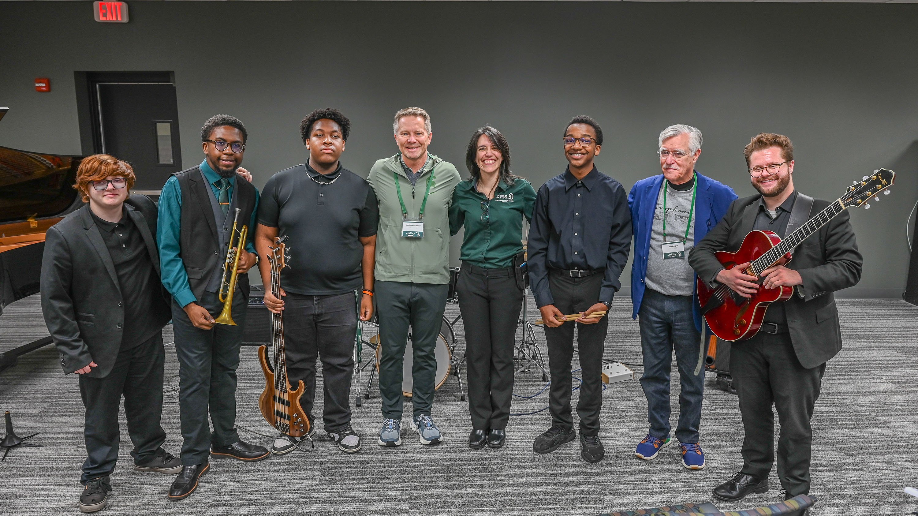 A group photo of young musicians with MSU administrators.