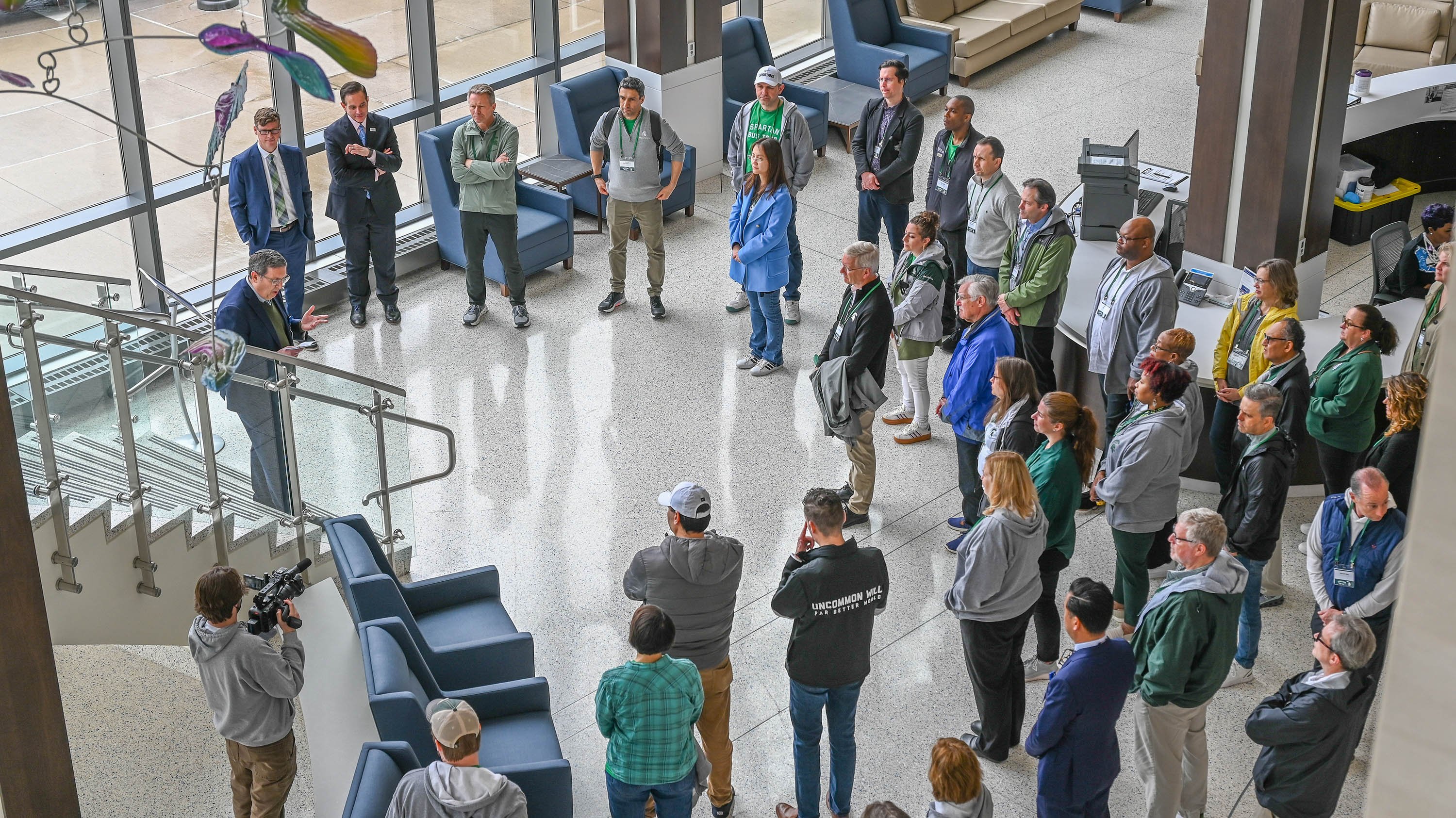 A group of people standing in a circle inside a building