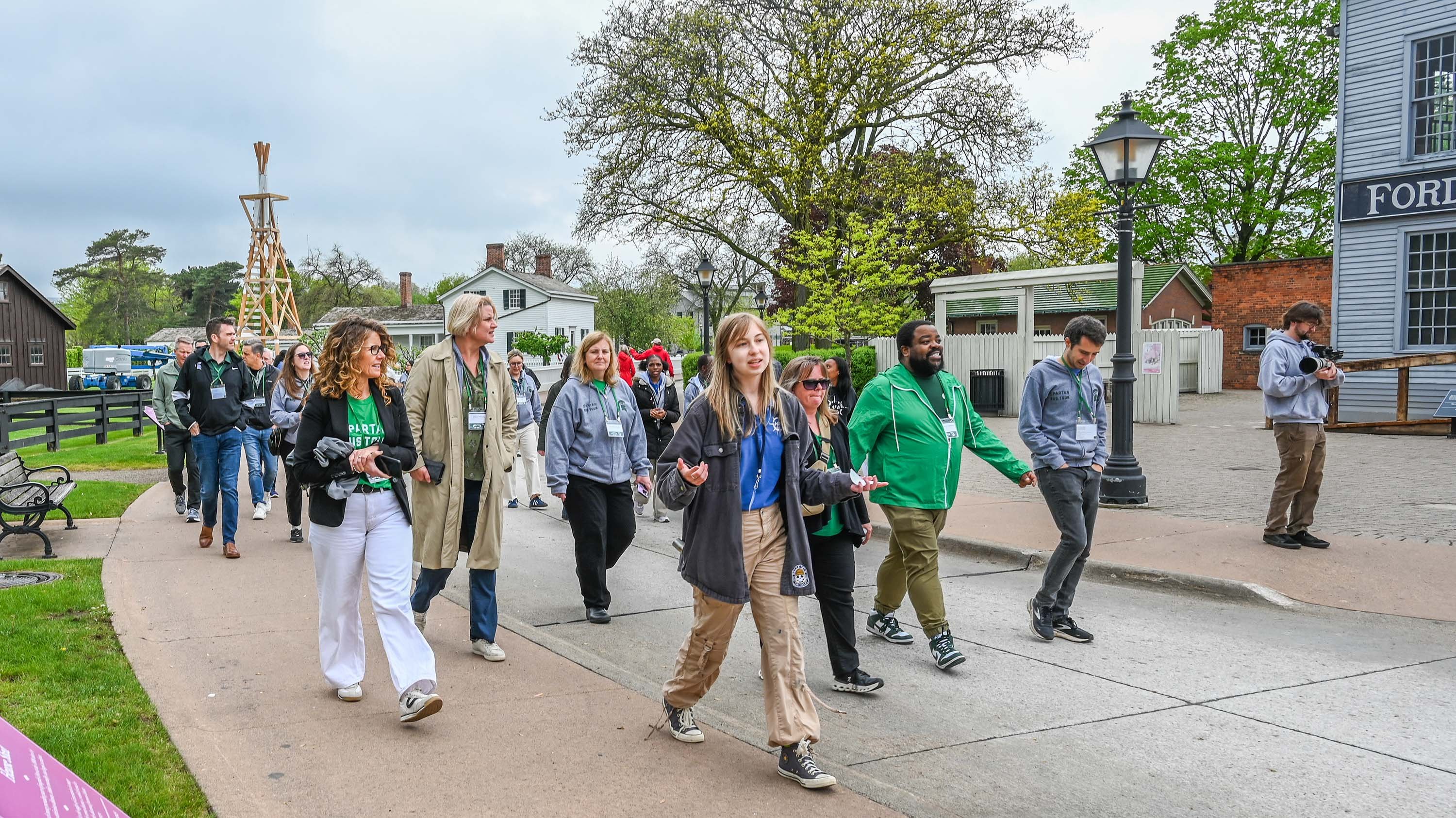 A group of people walking in a historical village