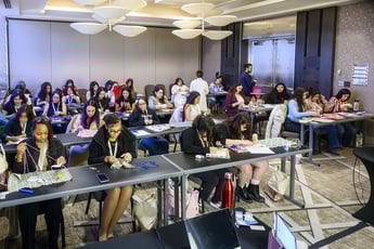 participants sitting at tables in a beading workshop