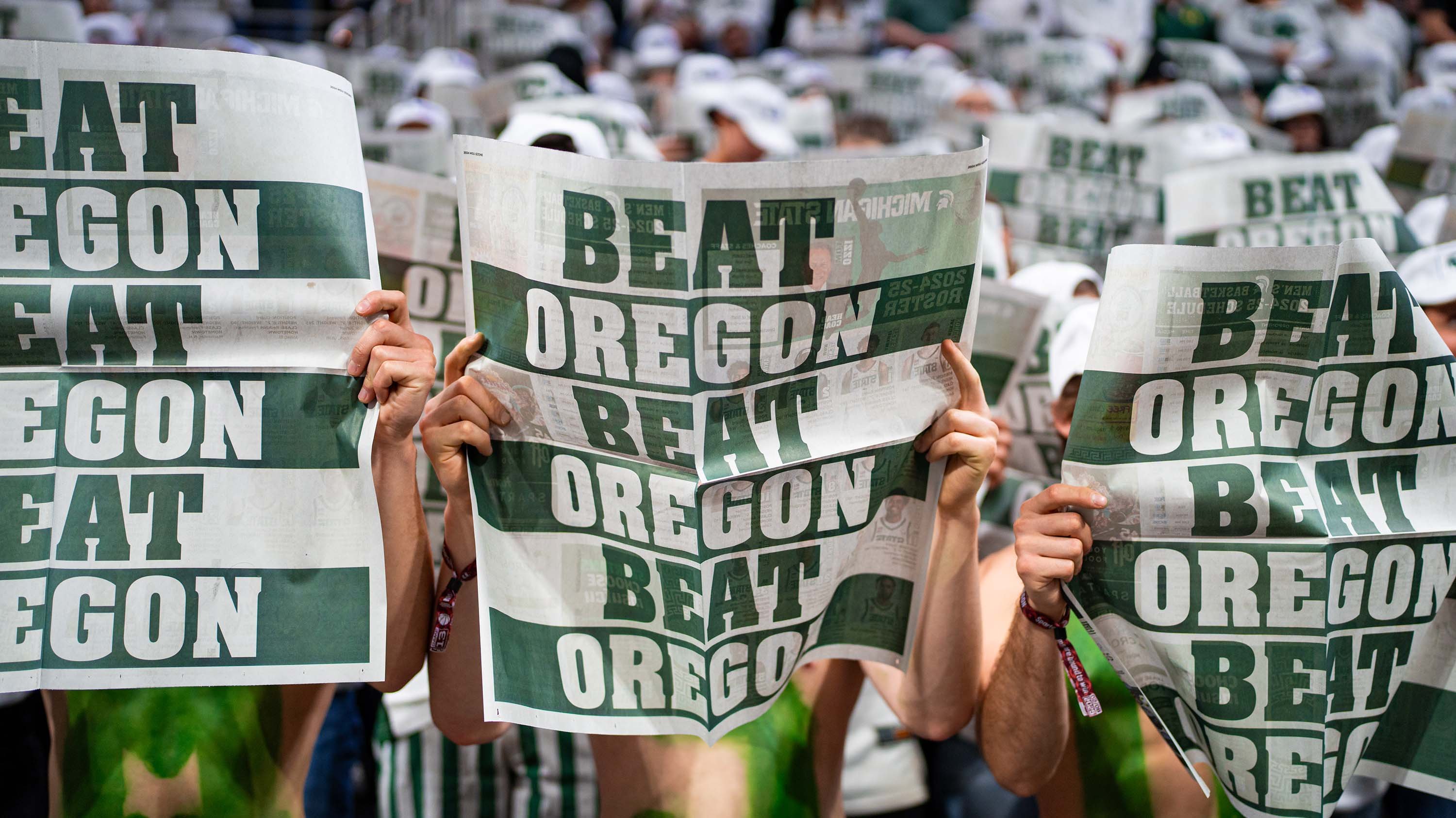 Izzone holding up Beat Oregon newspapers