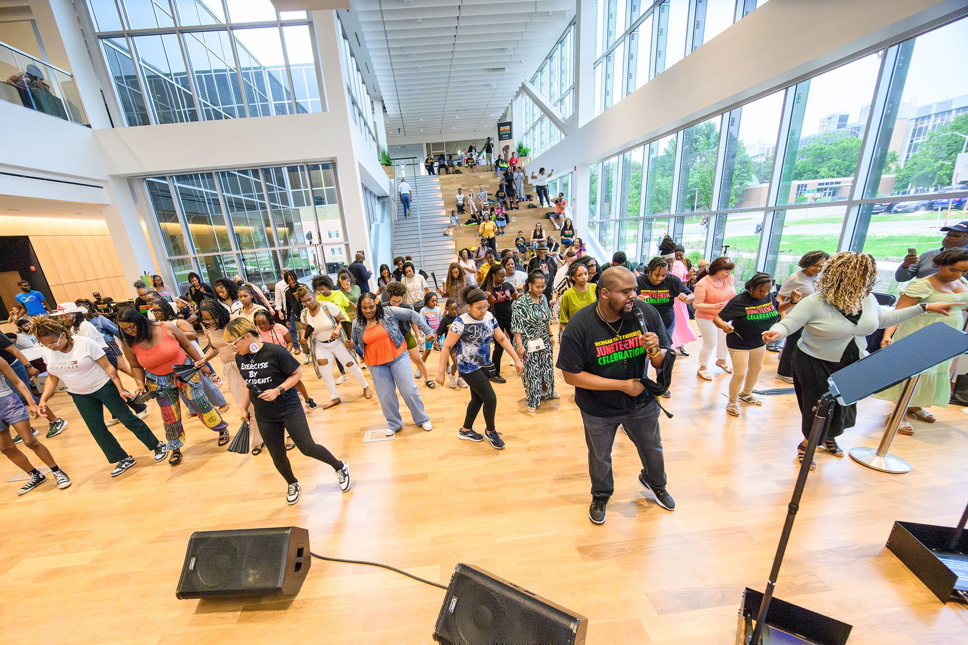 A large group participates in line dancing at the MSU Juneteenth Celebration 
