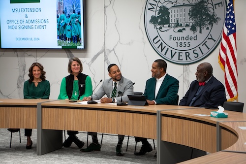 MSU officials gather at a meeting.