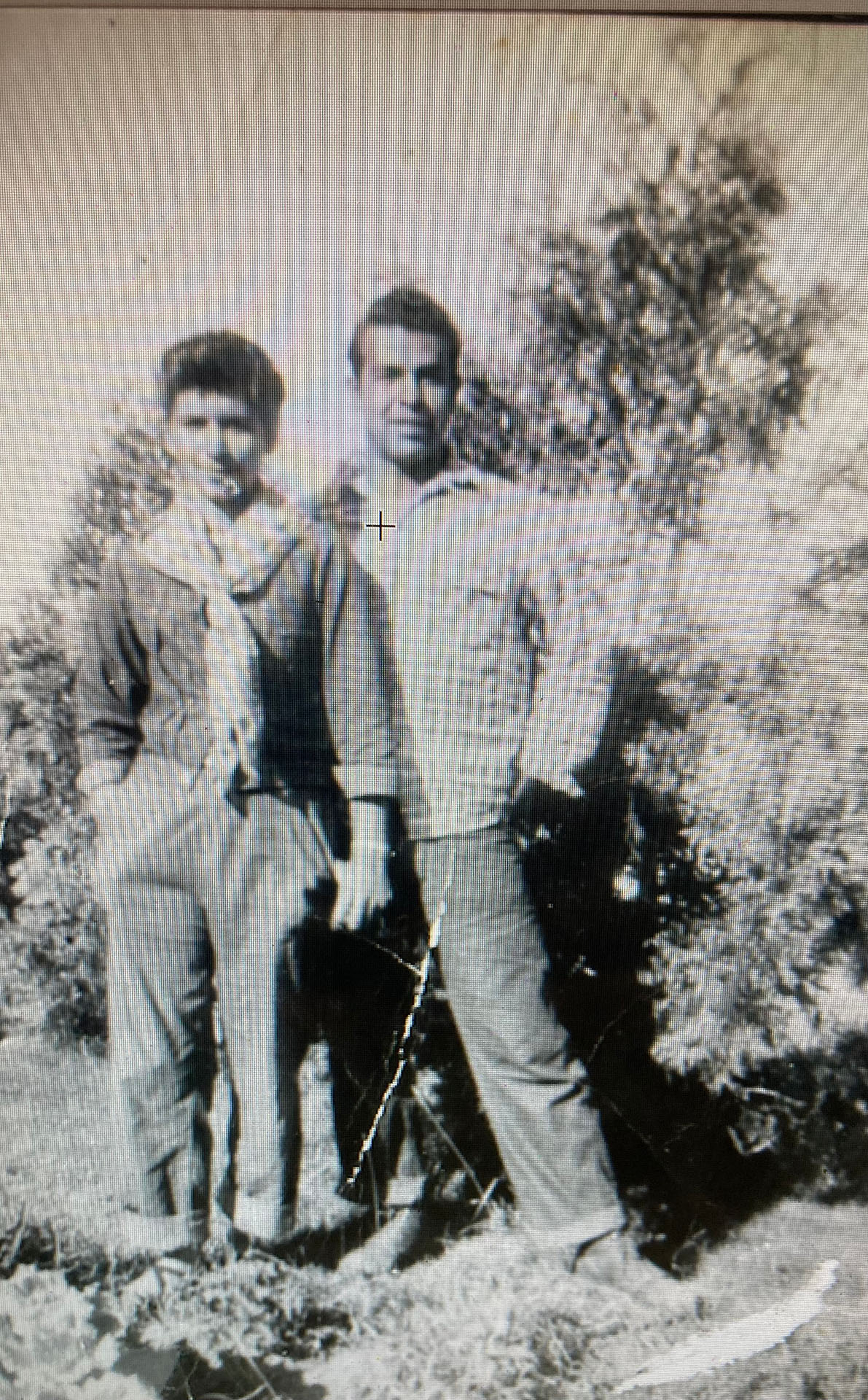 Black and white photo of Joe and Sarah Fuentes standing in front of a tree