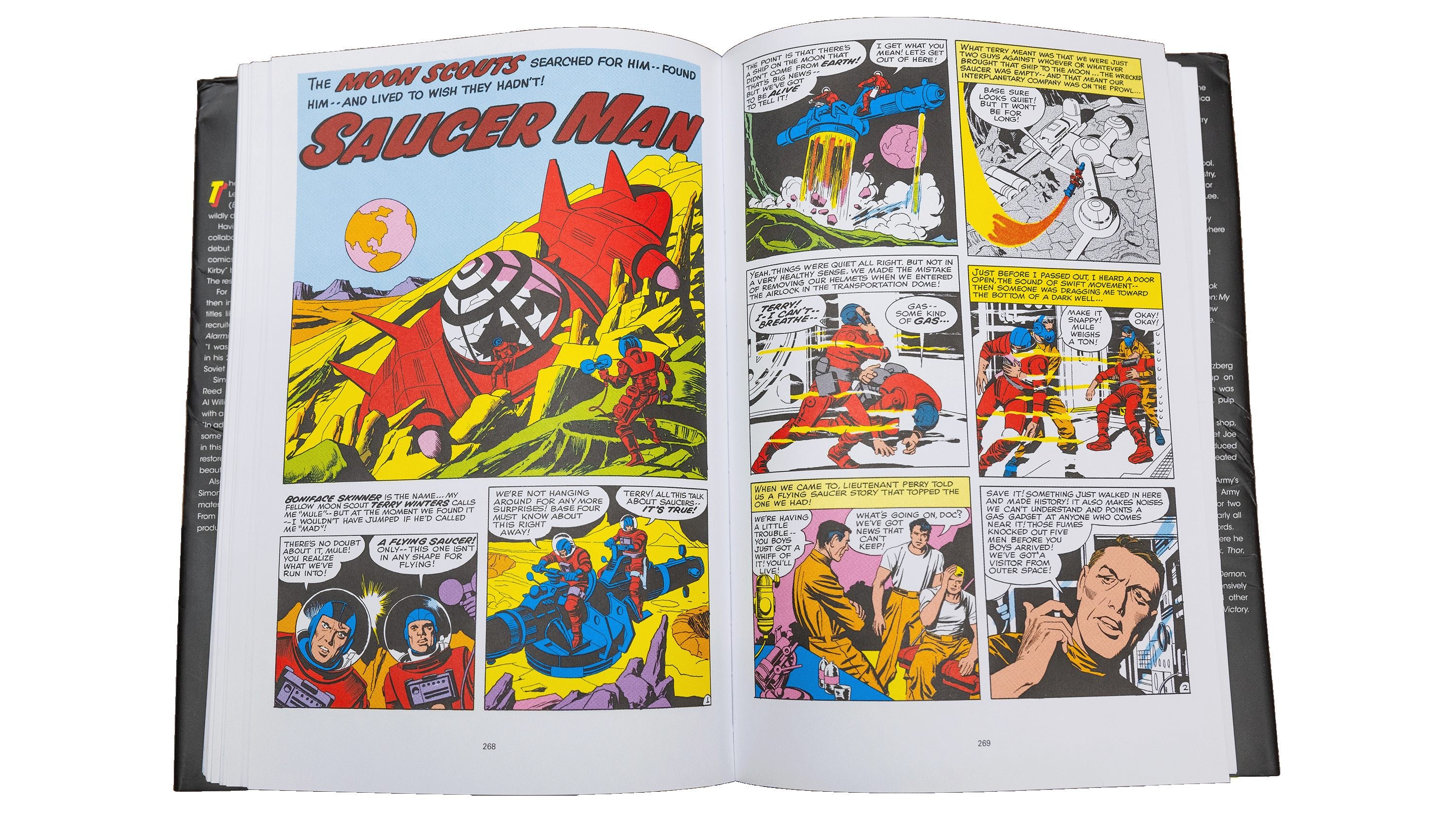 An open book showing a page of a comic book. The comic features illustrations of astronauts, spaceships, and a large, menacing alien creature. The text includes dialogue and captions.