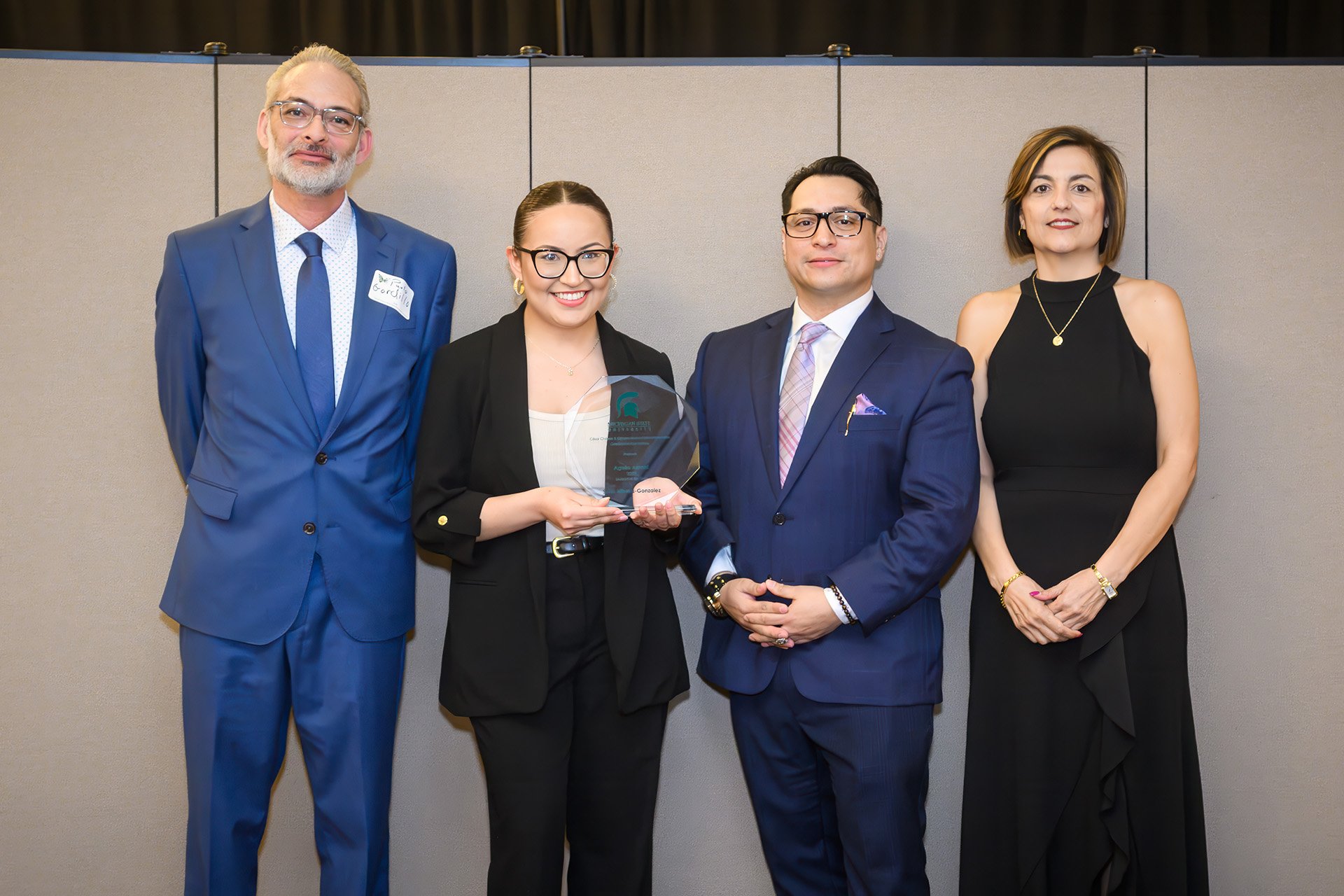 award recipient poses with award committee