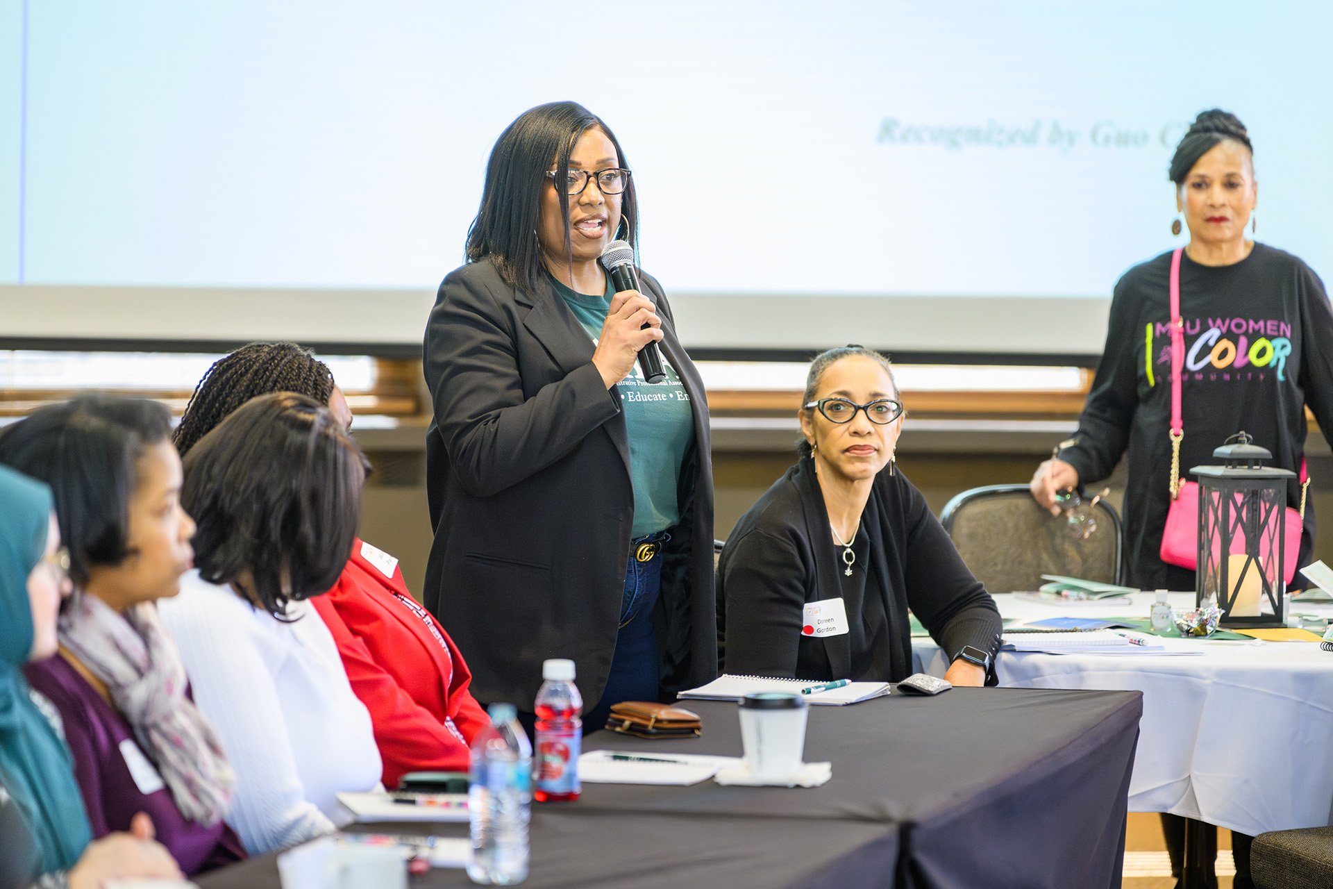 panelist speaks holding the mic