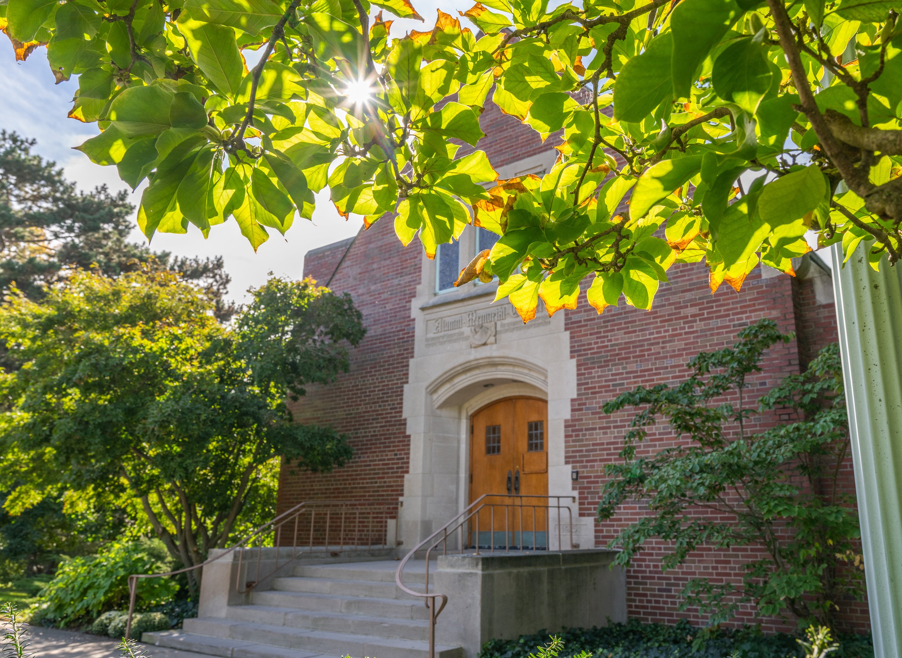 Alumni Memorial Chapel flanked  by fall trees.