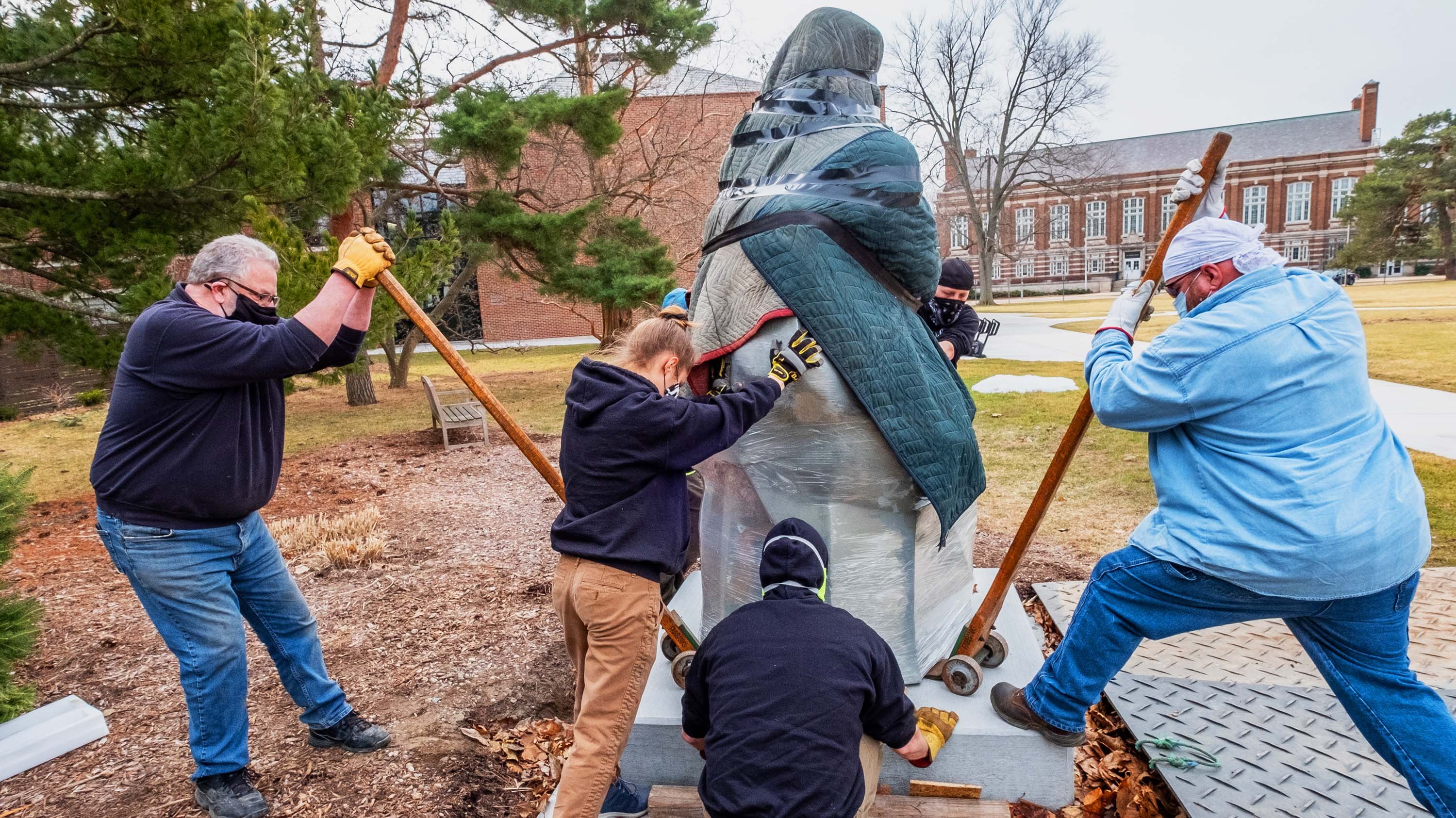 Crew installing a sculpture