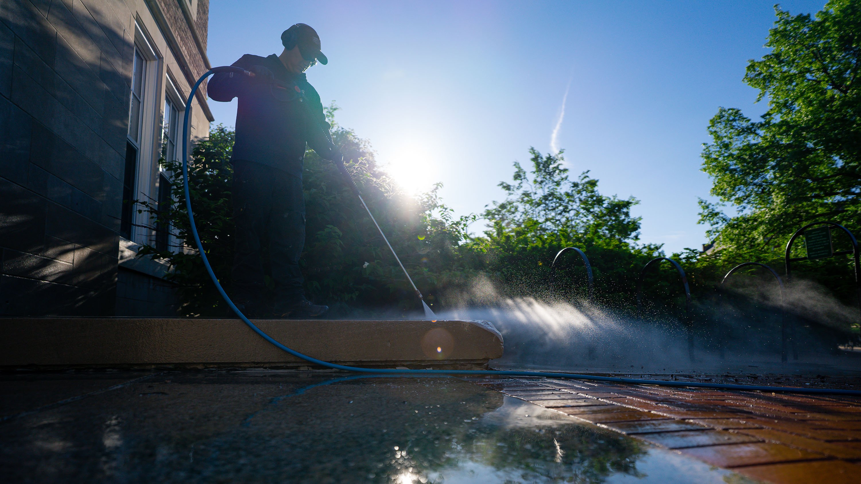 IPF crew using a power washer