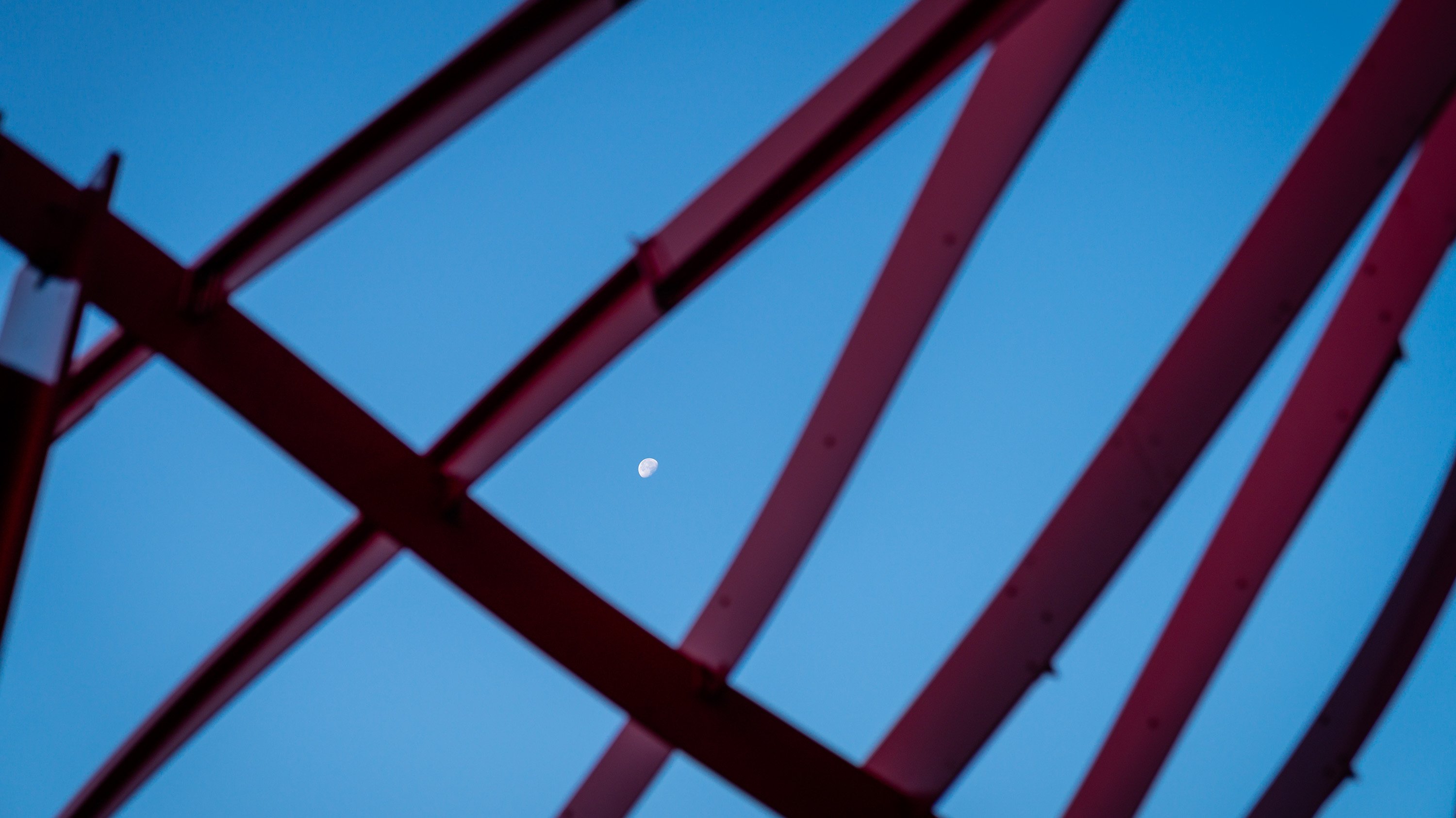 The moon viewed through the Wind raiser sculpture near BPS