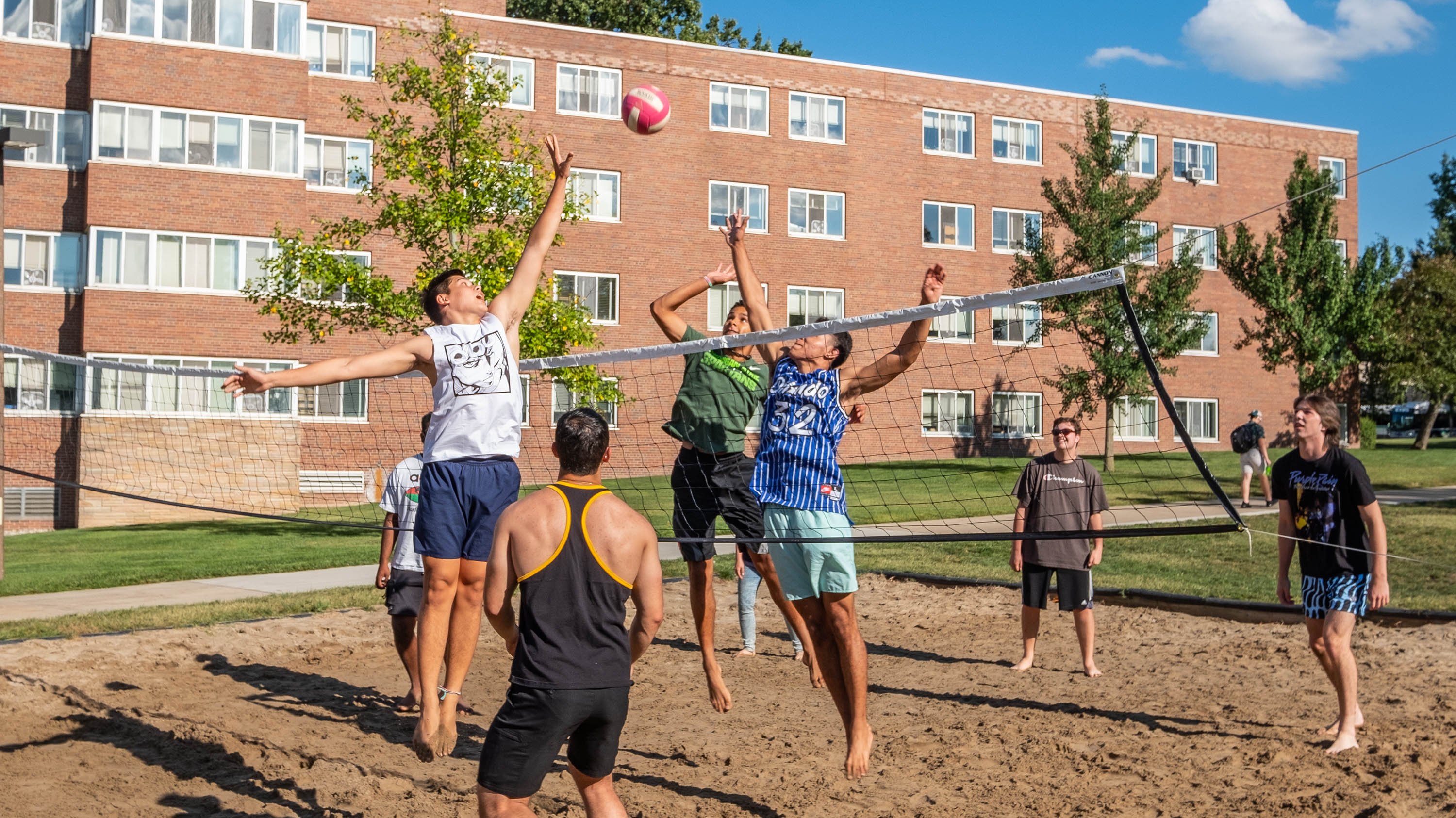 Students playing volleyball outside of Shaw Hall