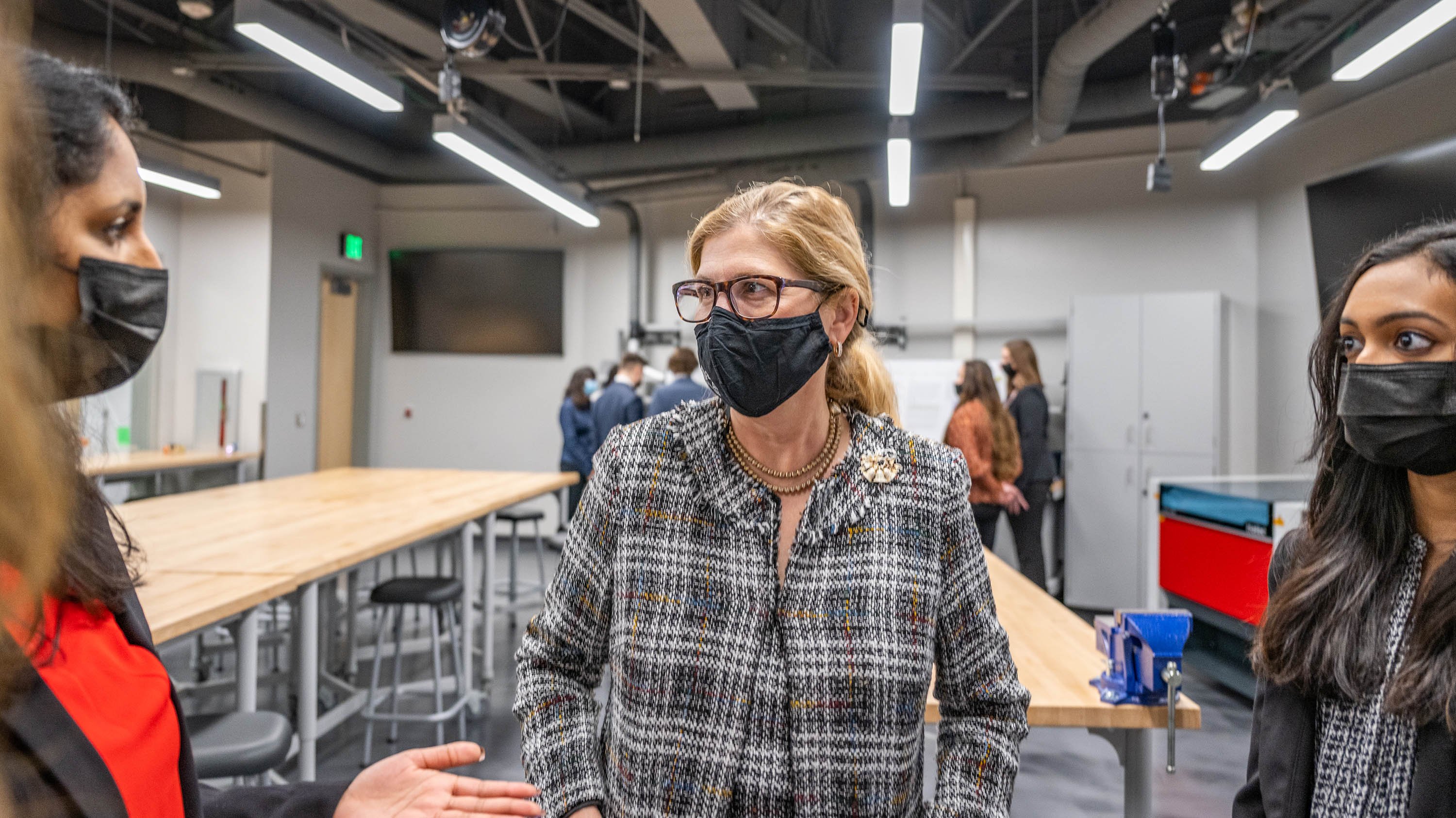 Provost Teresa Woodruff listens to students at the official opening of the College of Engineering's Student Innovation Center in Wonders Hall