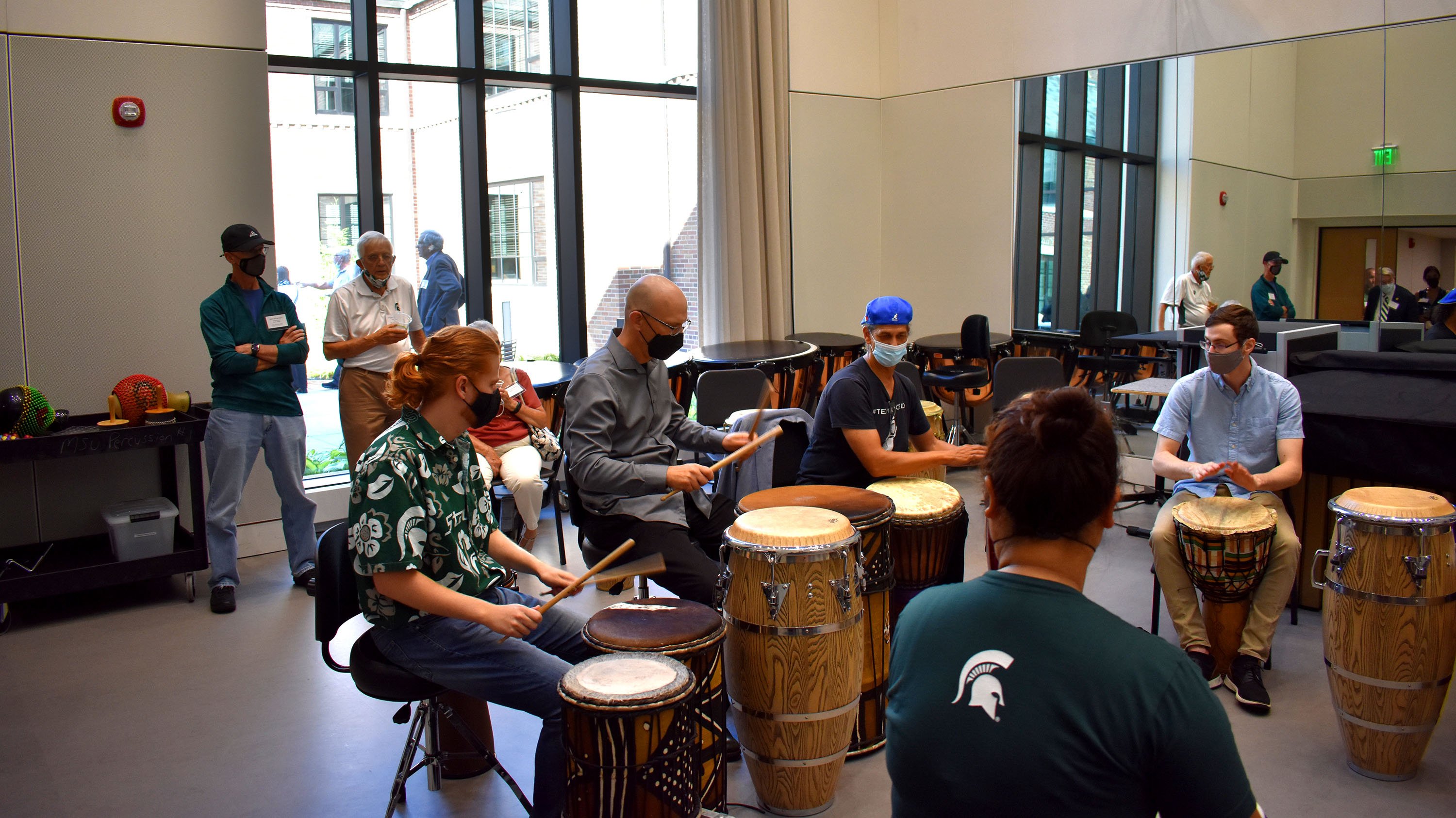 Faculty member Jon Weber (center, long sleeves) plays with Percussion Studio students in the Shalon Percussion Rehearsal Hall.