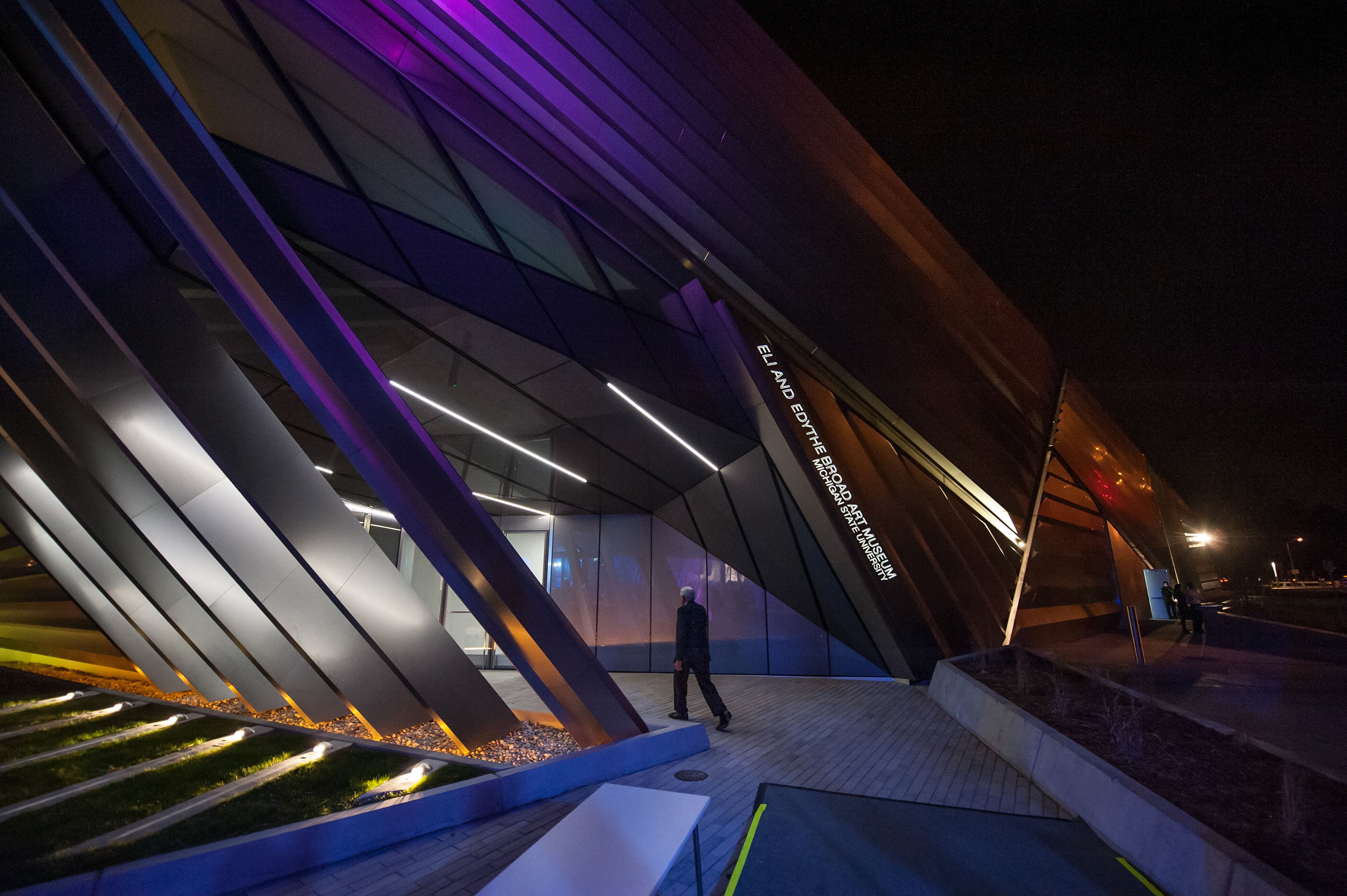 Eli Broad in front of the MSU Broad Museum at night.