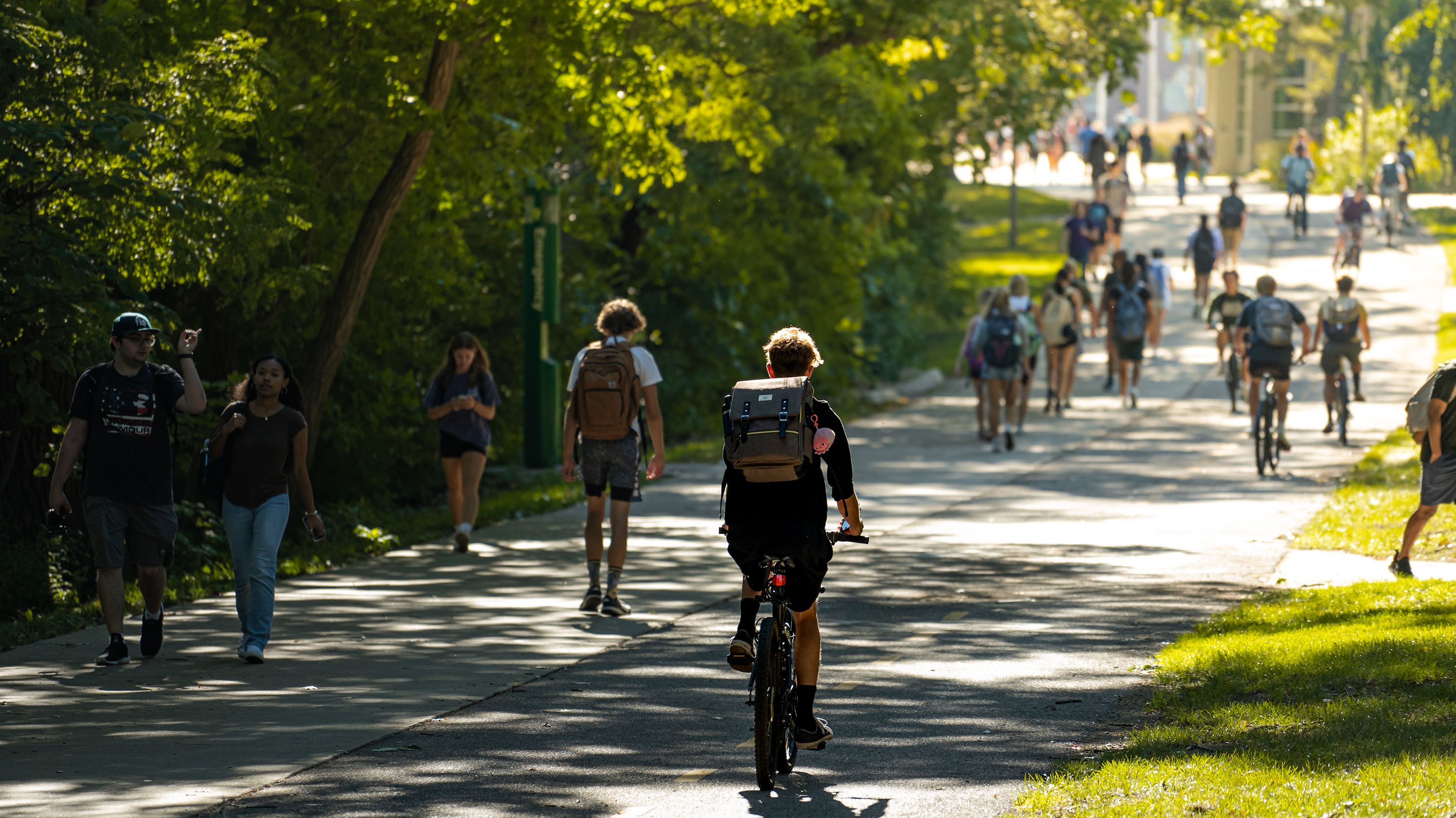 People walking and biking on river trail path