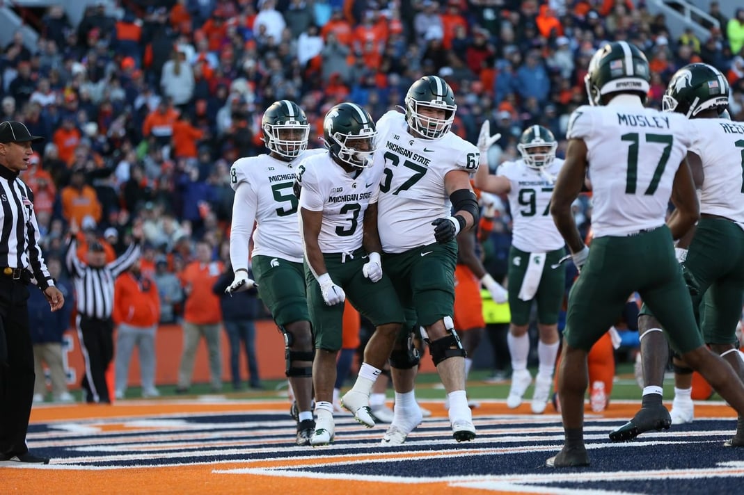 The MSU offense celebrates a touchdown at Illinois