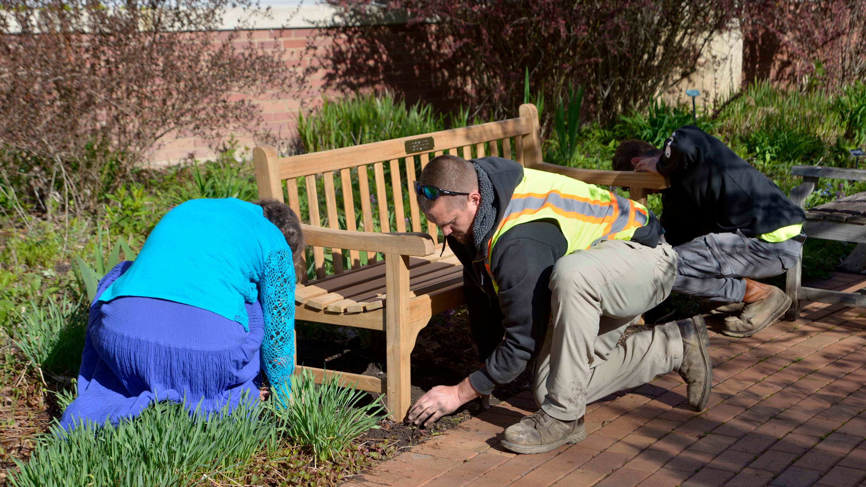 People installing a bench in the Radiology Healing Garden