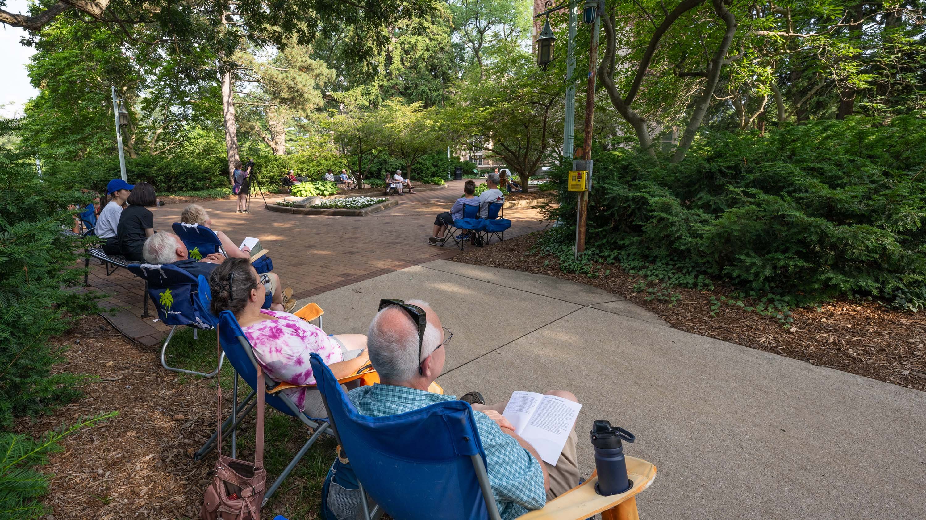 People sitting outside Beaumont Tower during summer concert series