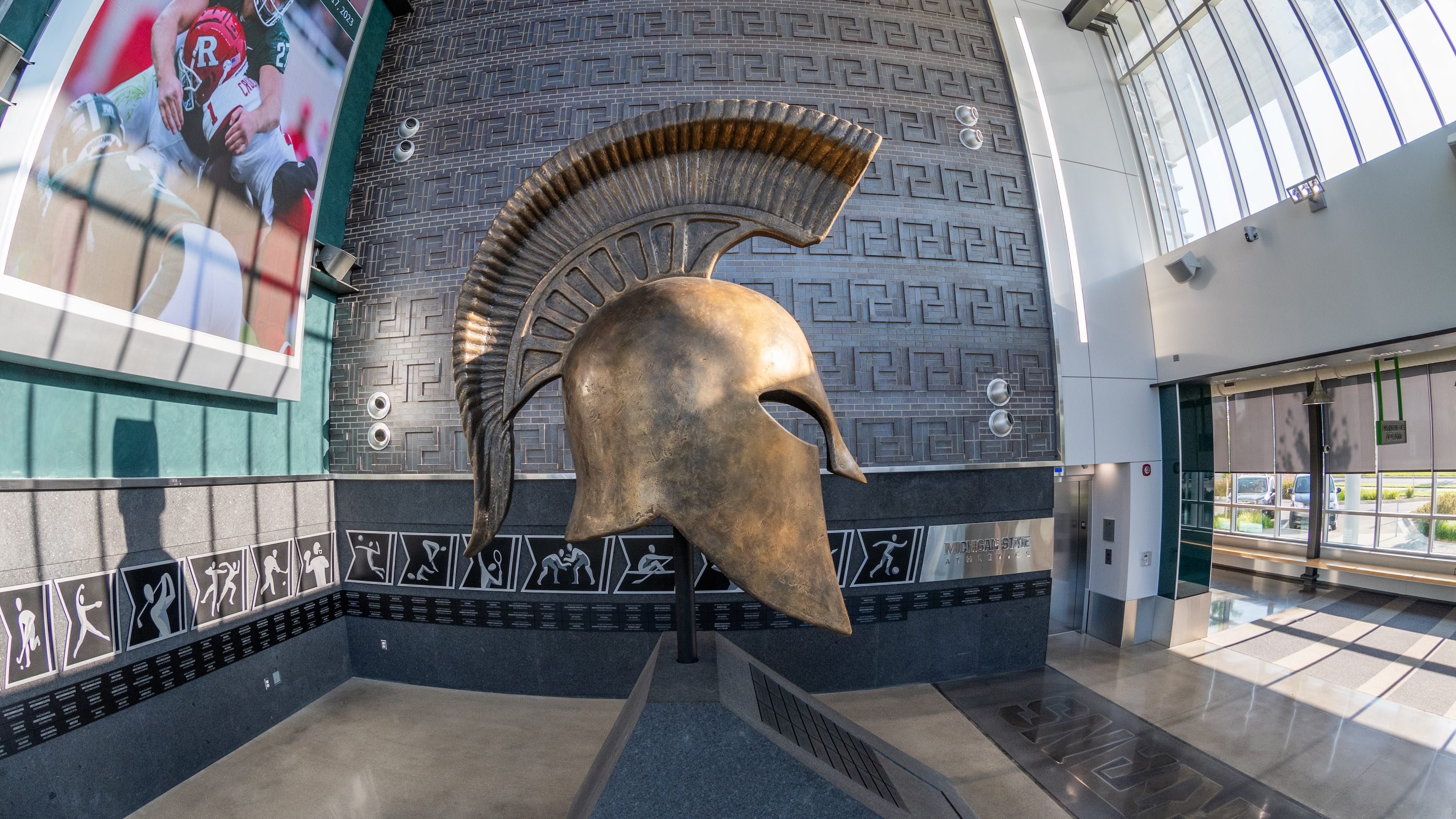 A profile view of a sculpture of a bronze spartan helmet