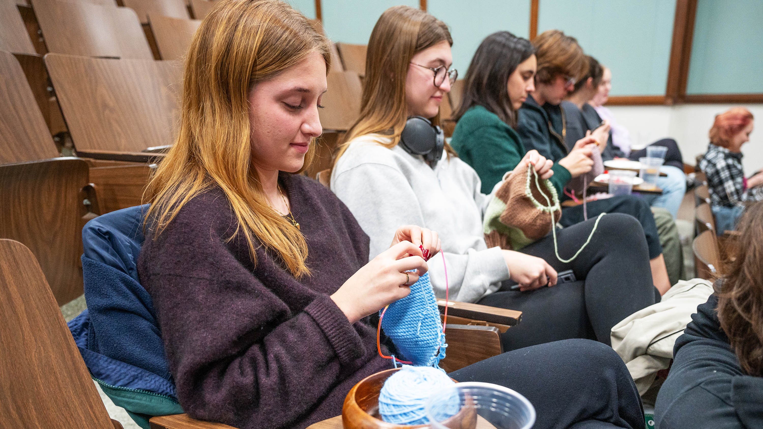 Students knitting in lecture room at Olds Hall