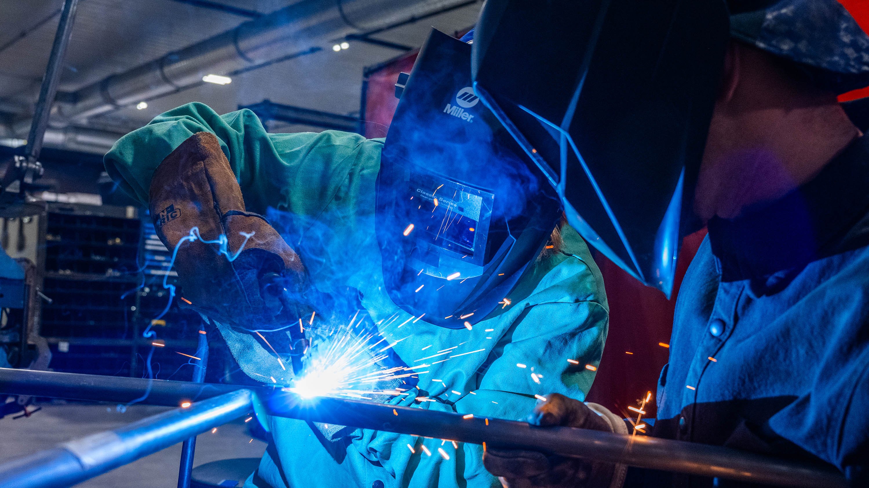 Theresa K. Woodruff welding with a member of the Solar Car team