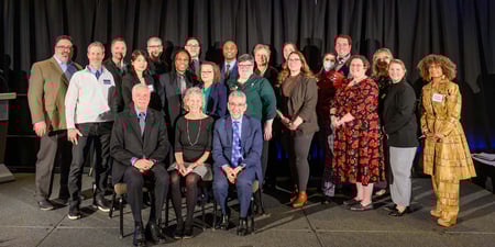 a large group of award recipients on stage