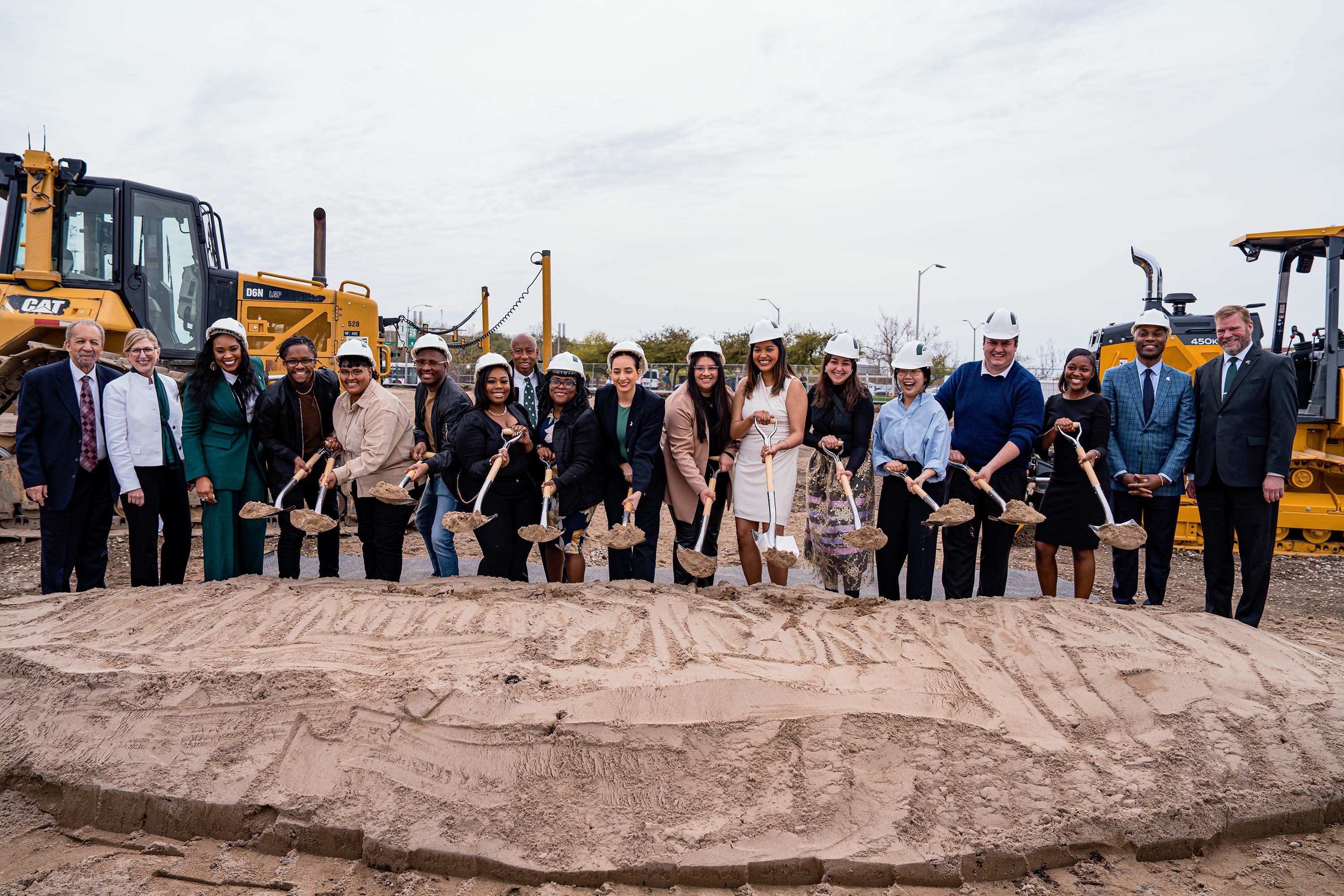 Attendees of multicultural Center groundbreaking with shovels