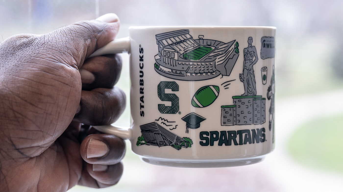 Hand holding Starbucks 'Been There' mug