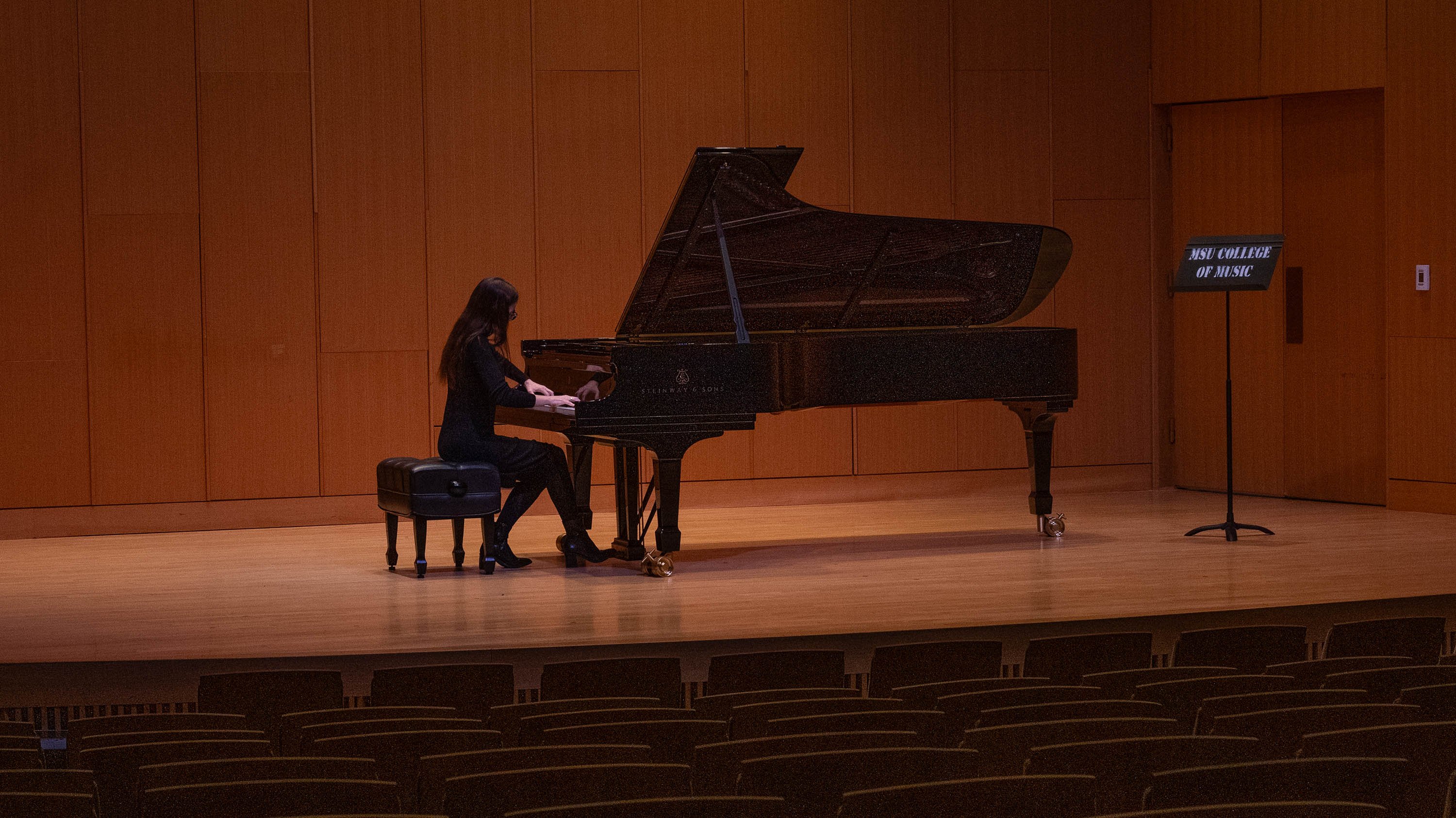 Student at piano during music finals exam
