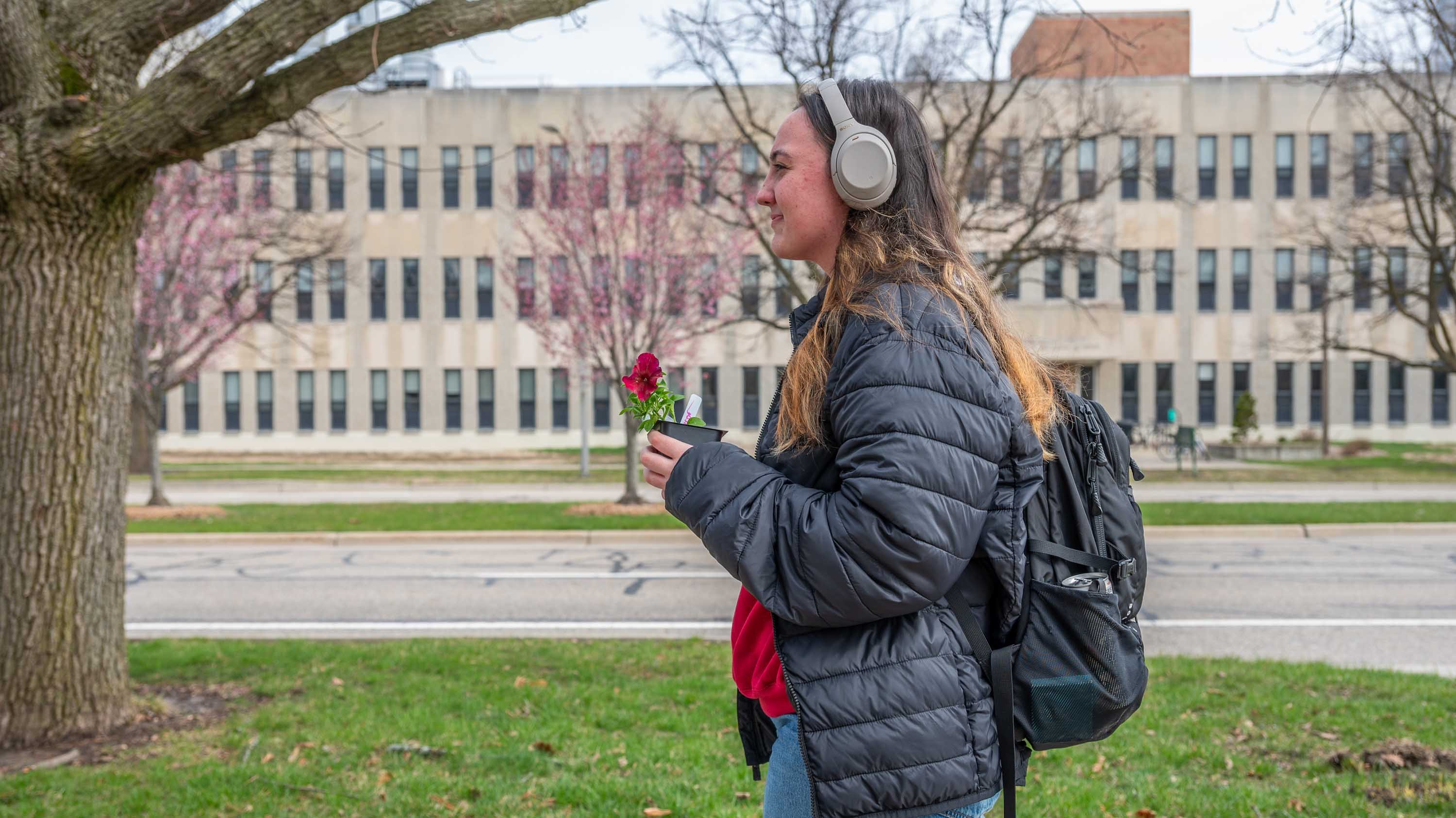 Student carrying flower