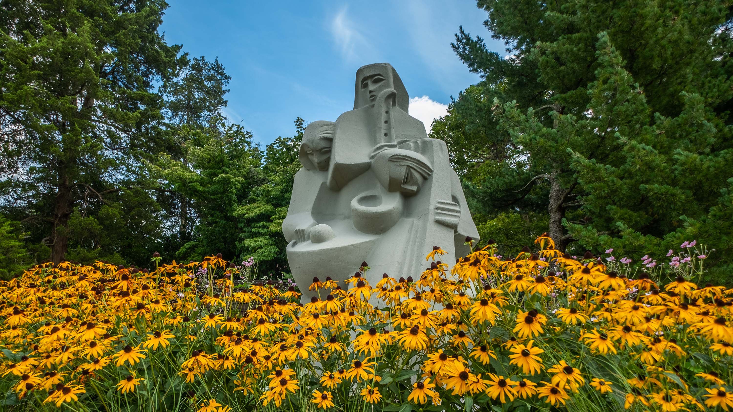 Three Musicians sculpture and flowers