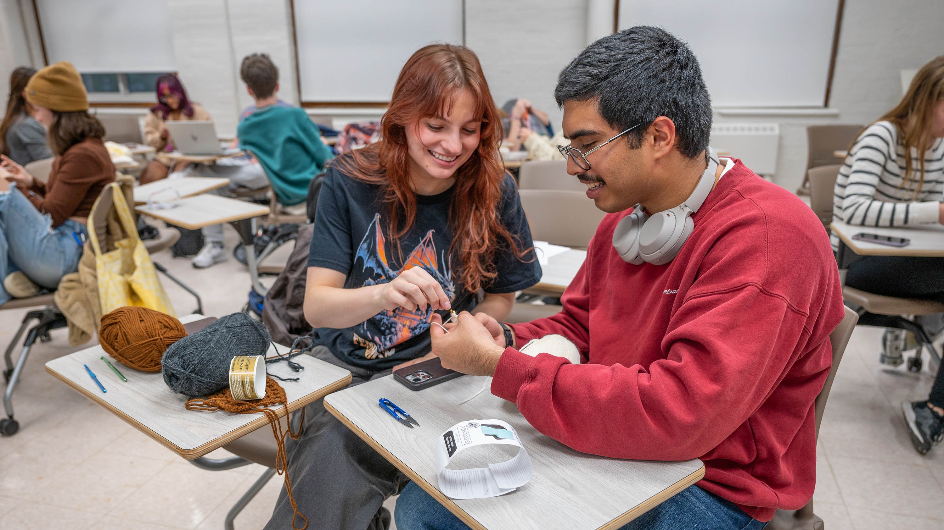 Two students crocheting in MSU Yarn Circle meeting