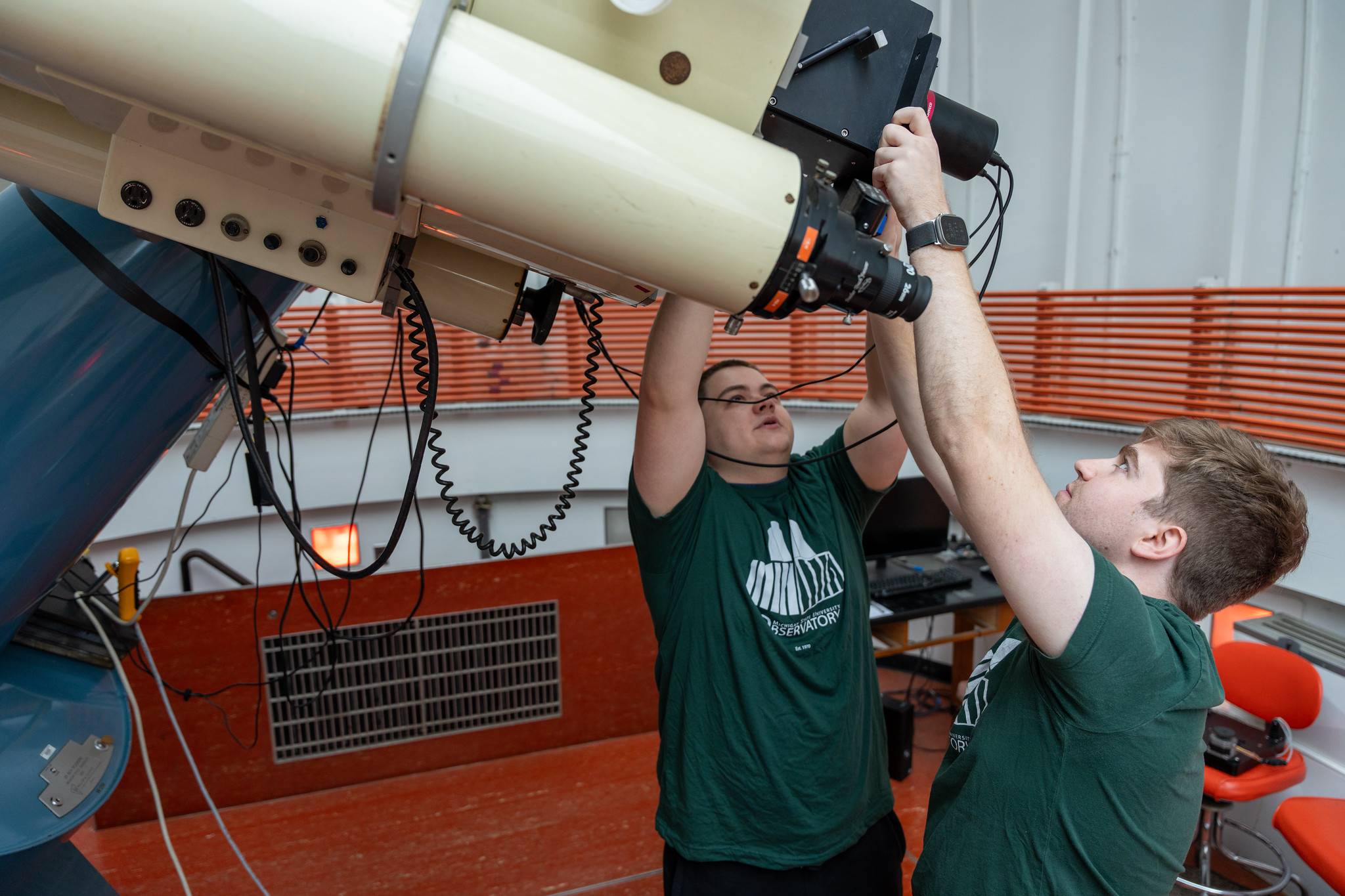 Cameron See and Jack Schulte adjust the MSU Observatory's research telescope.